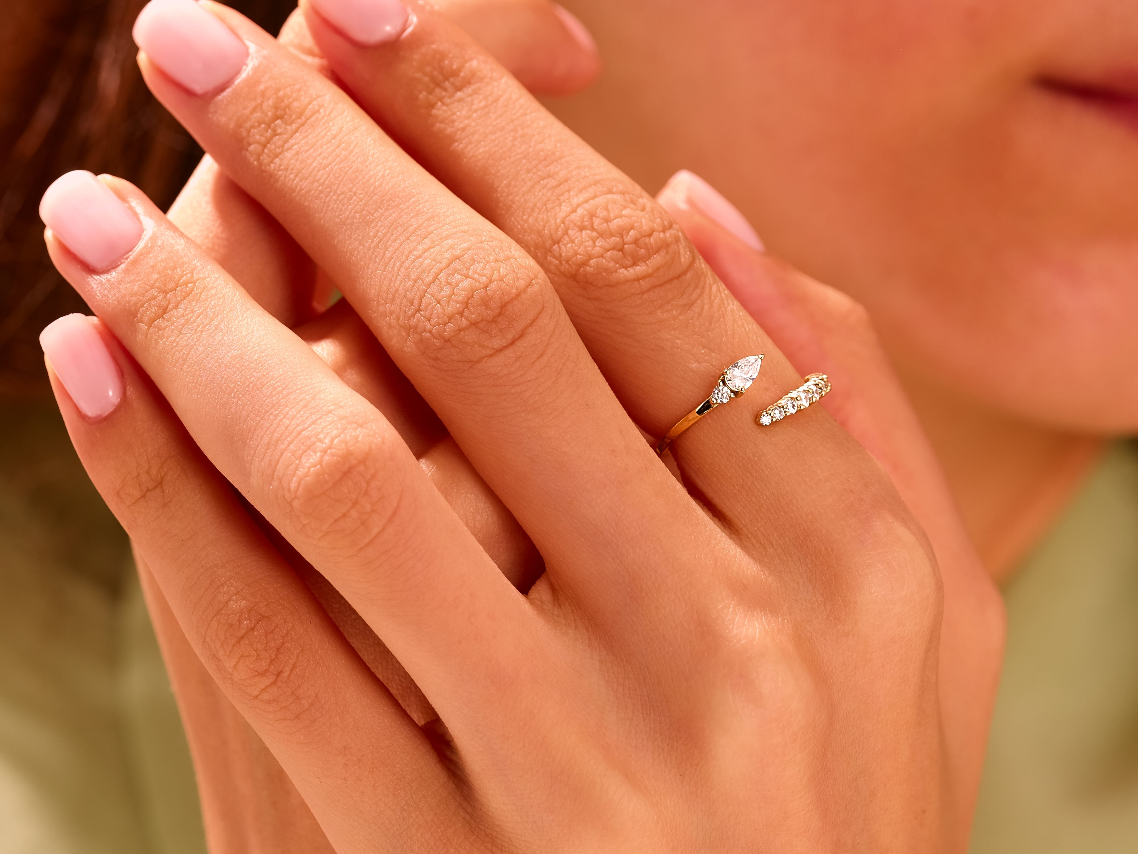 Gold diamond ring on a hand, elegant jewelry for women