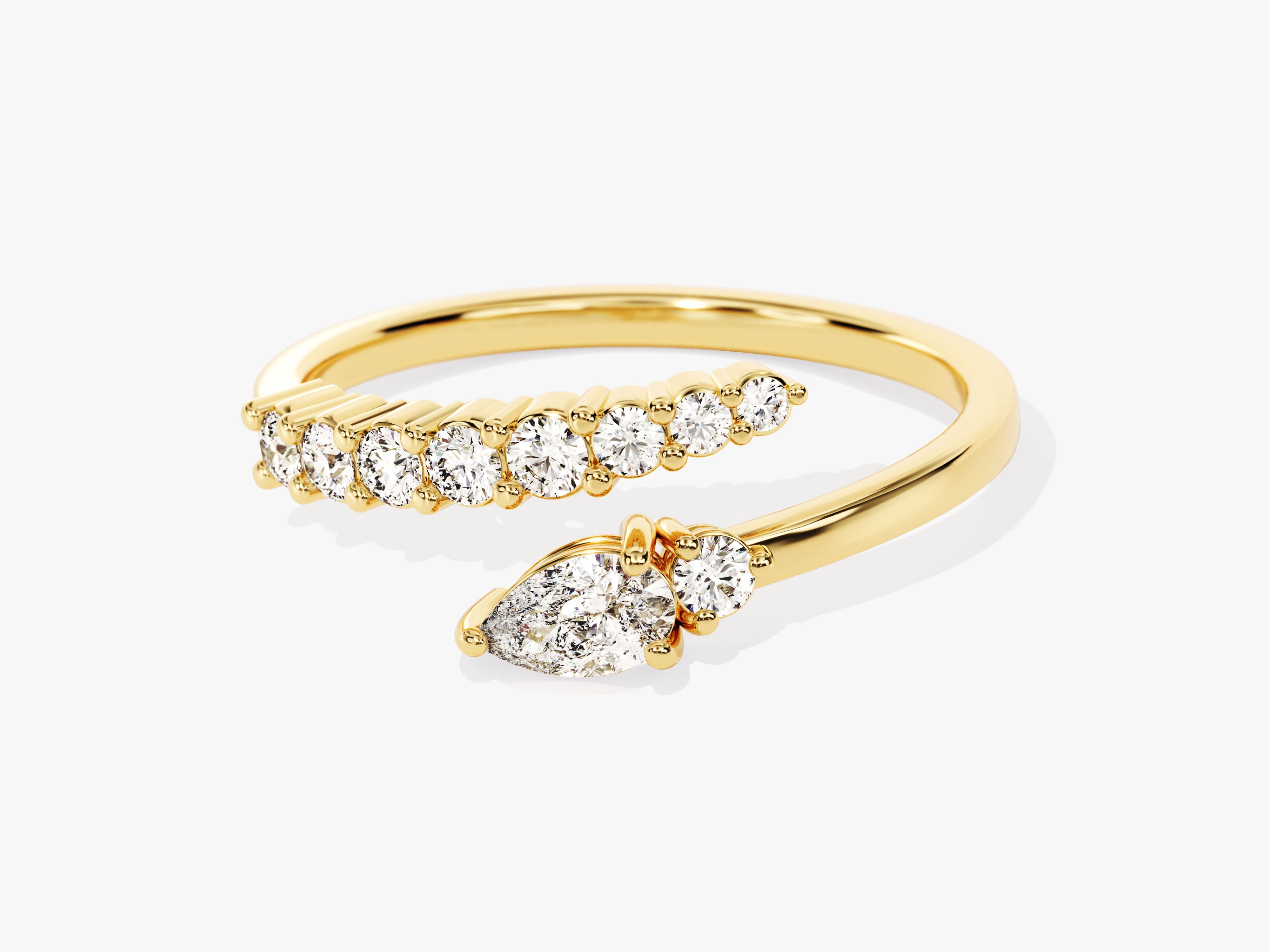 Gold diamond bypass ring with pear and round cut stones