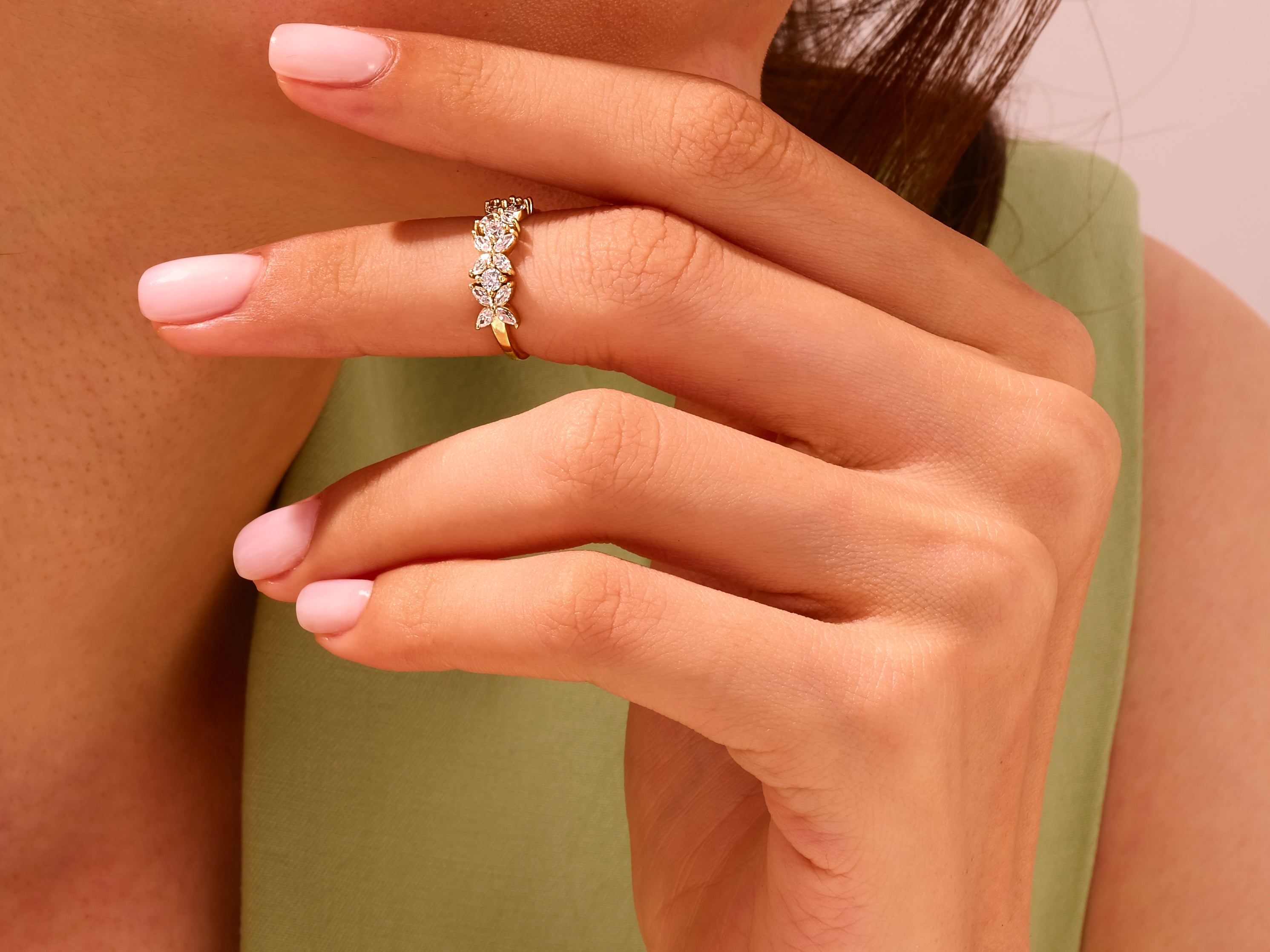 Gold diamond ring with floral design on a woman's hand