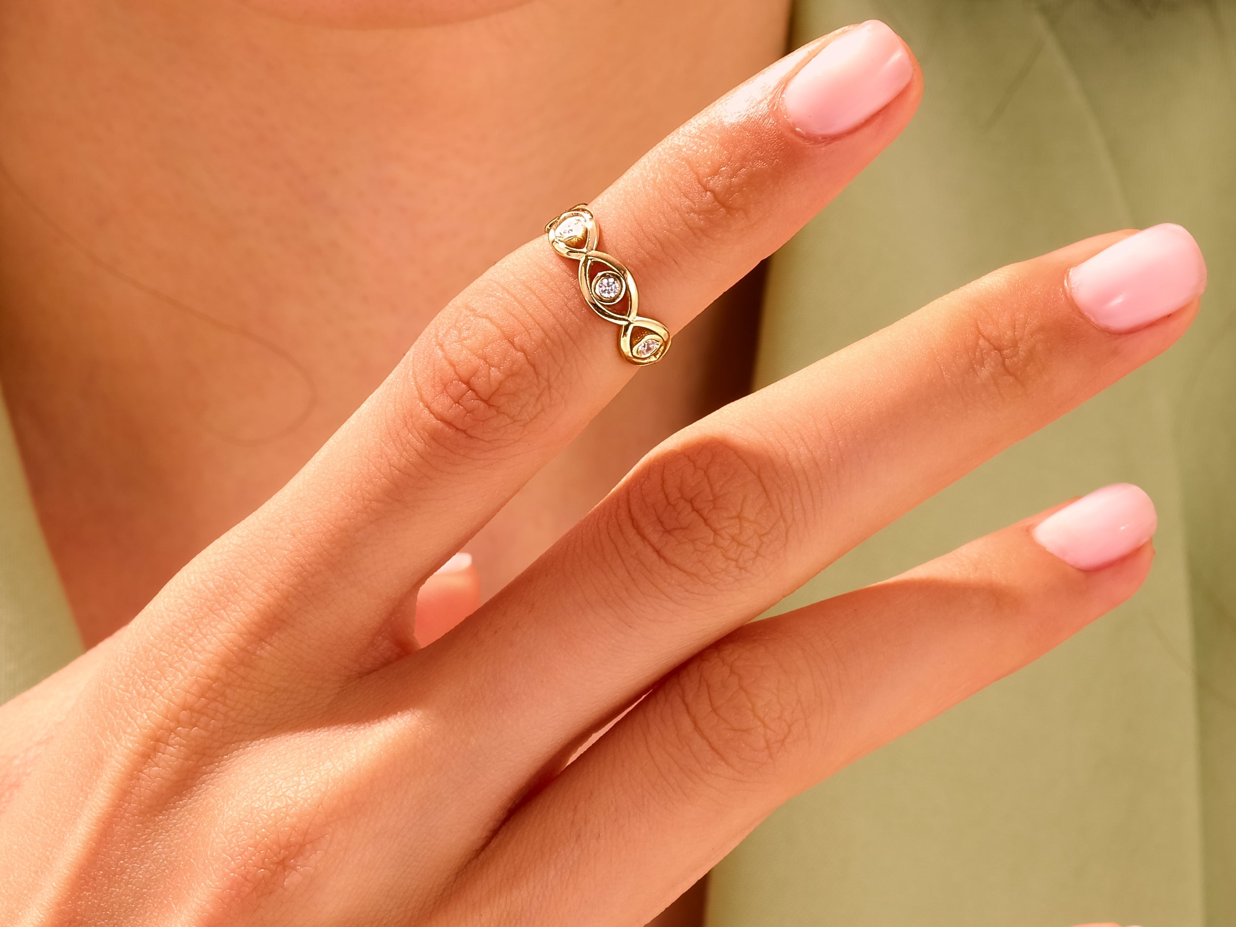 Gold diamond ring with marquise design on finger