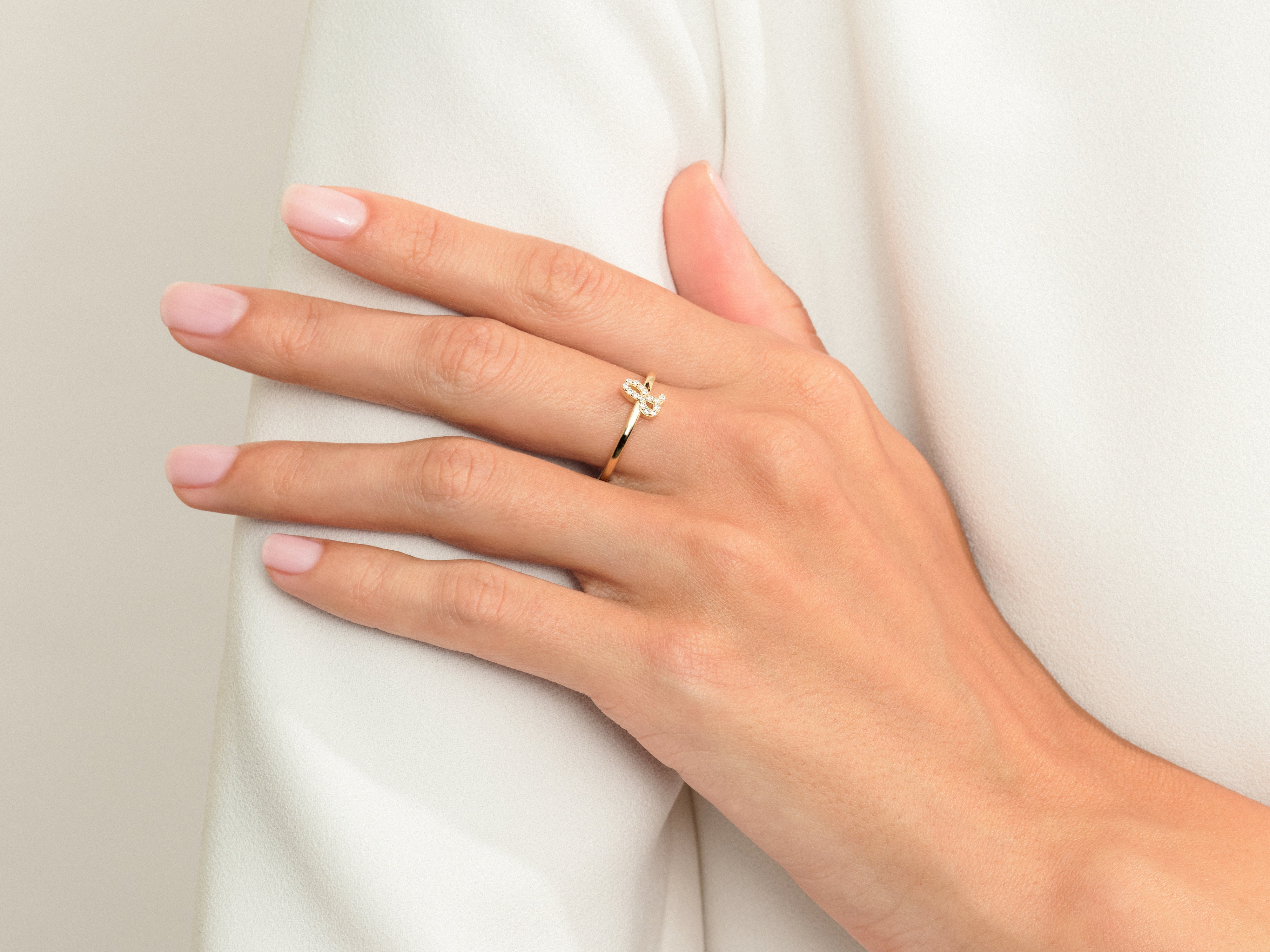 Gold diamond butterfly ring on a woman's hand
