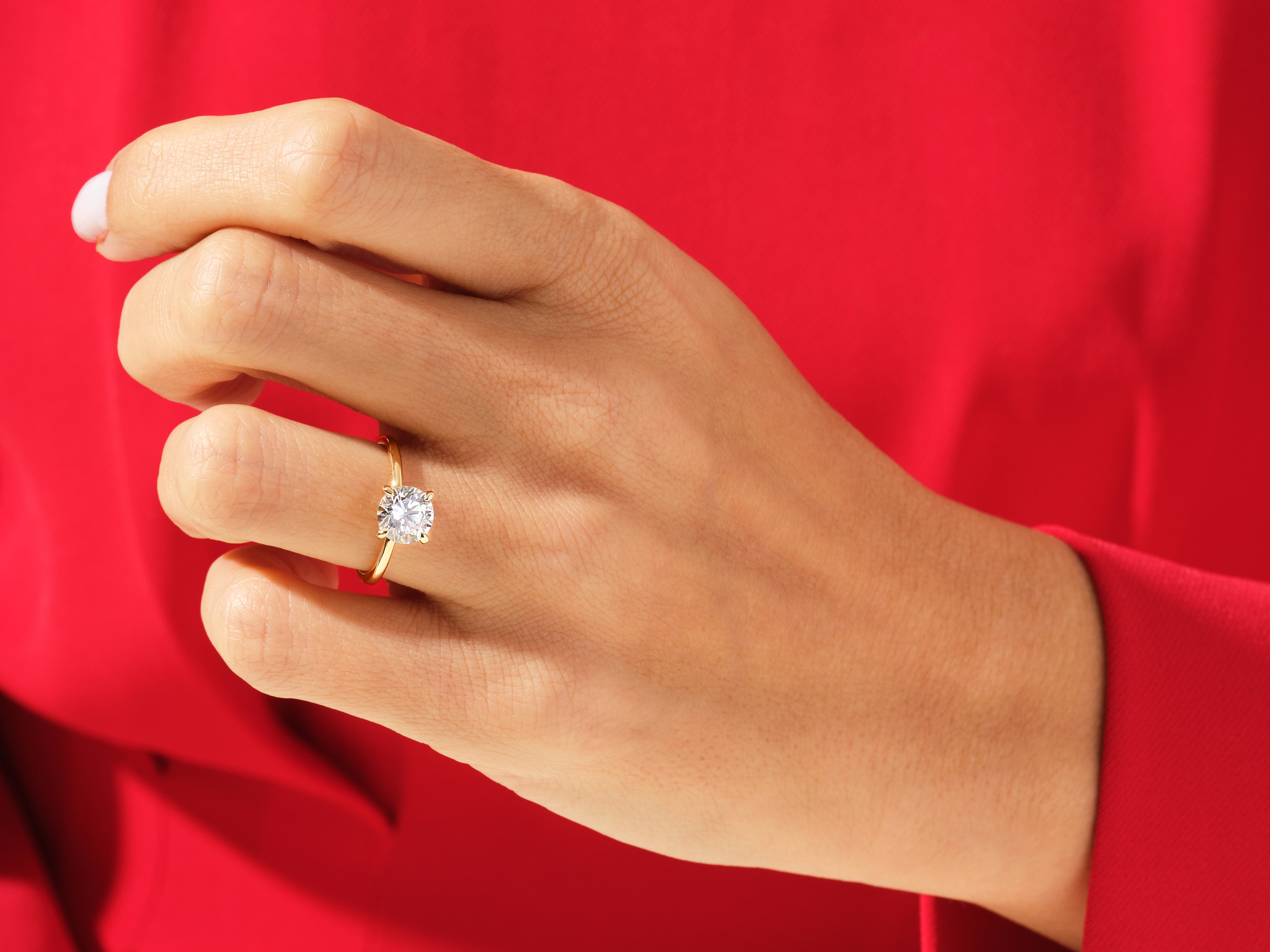 Diamond engagement ring on a hand, jewelry product photography