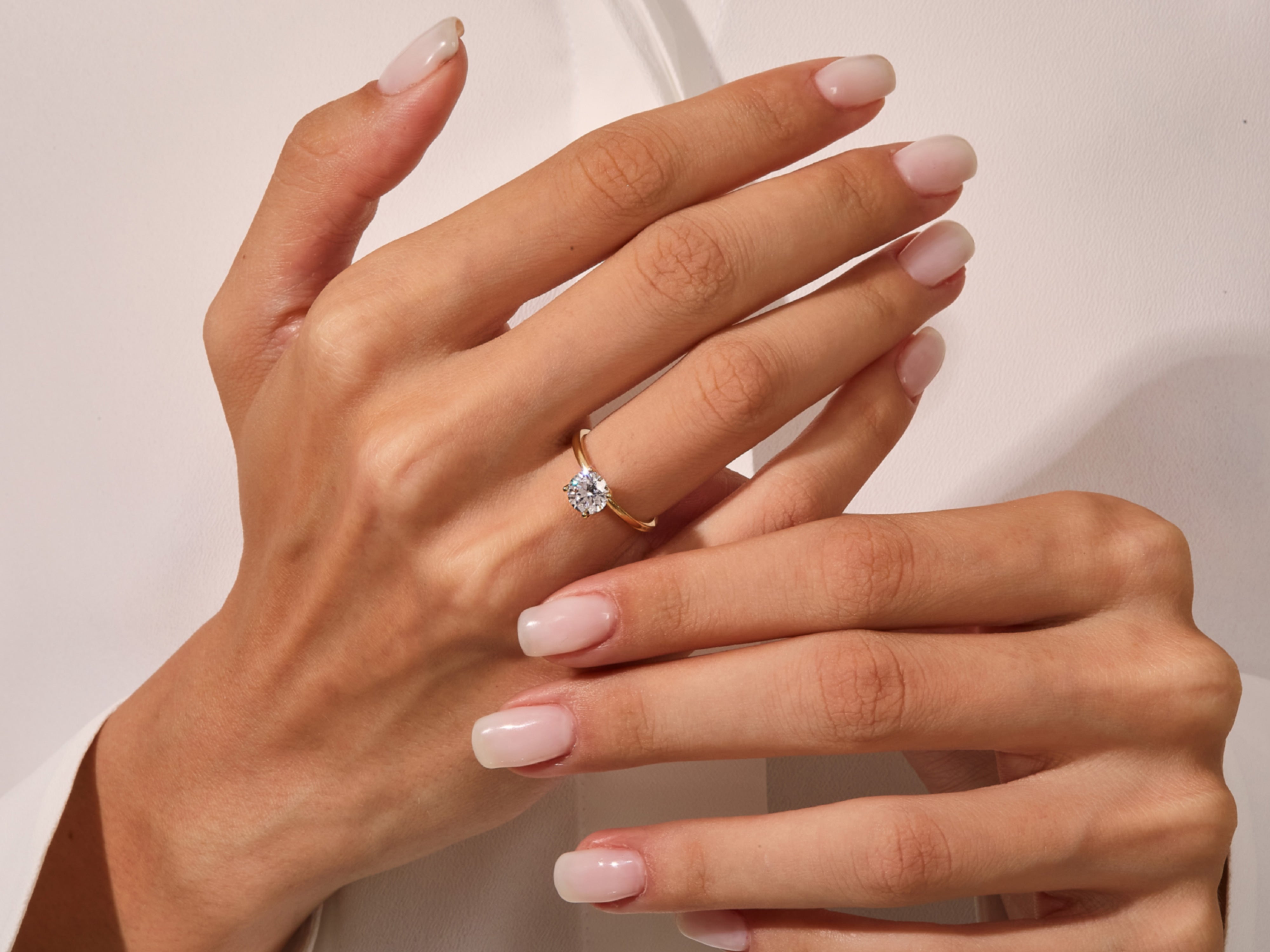 Diamond solitaire ring on a woman's hand, fine jewelry