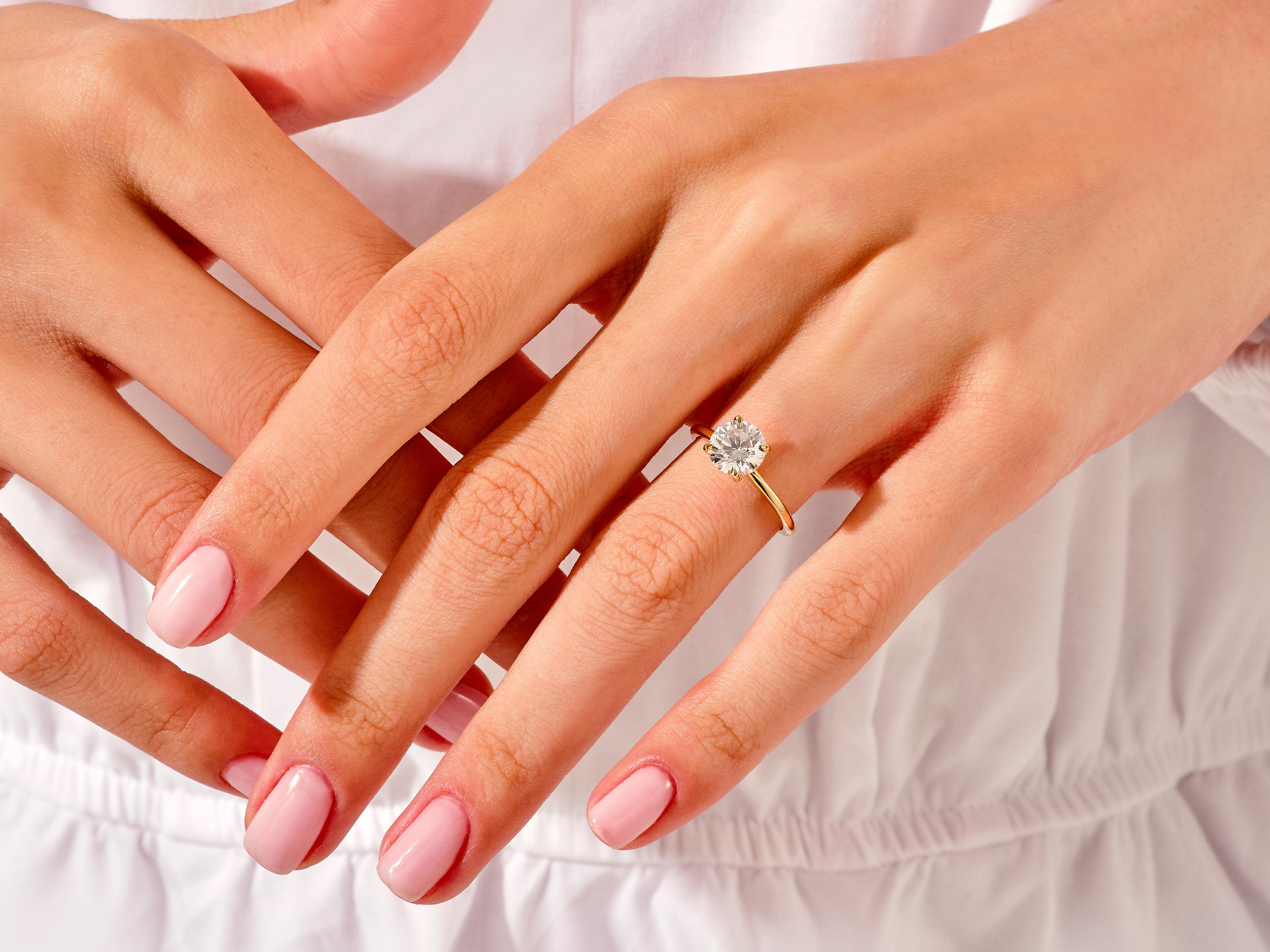Gold diamond engagement ring on a woman's hand