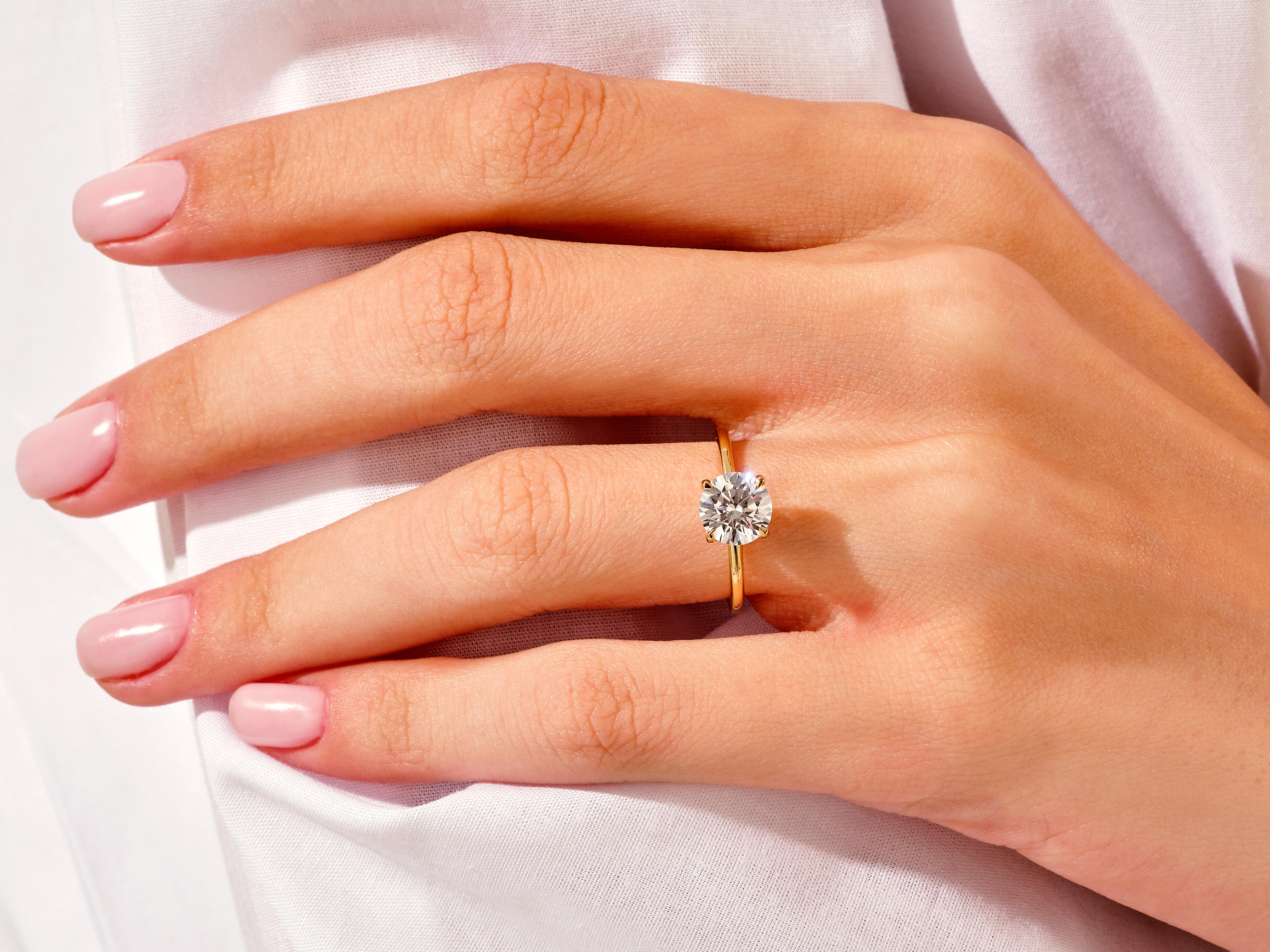 Diamond solitaire ring on a woman's hand, jewelry photography