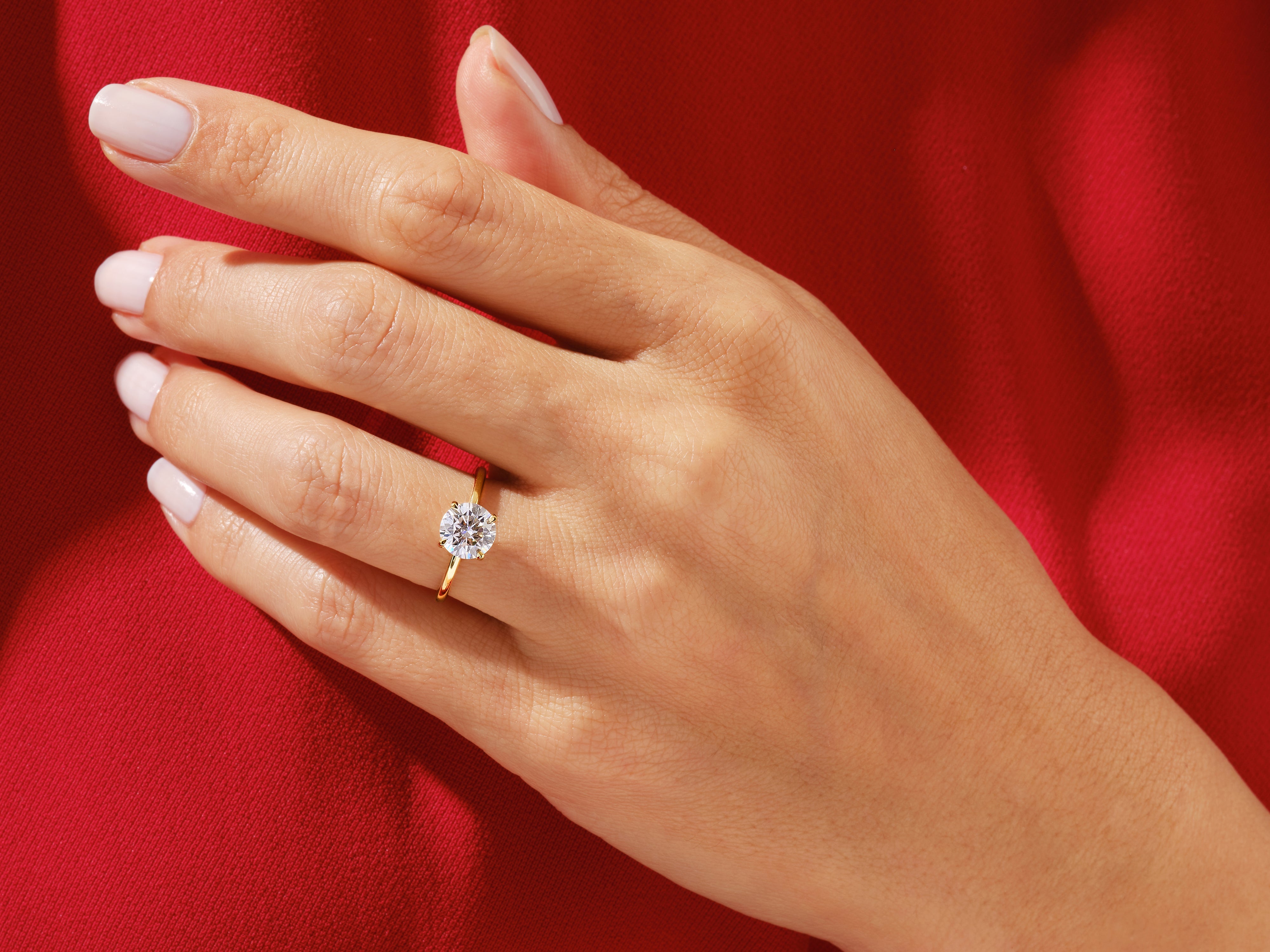 Diamond engagement ring on a hand, jewelry product photography