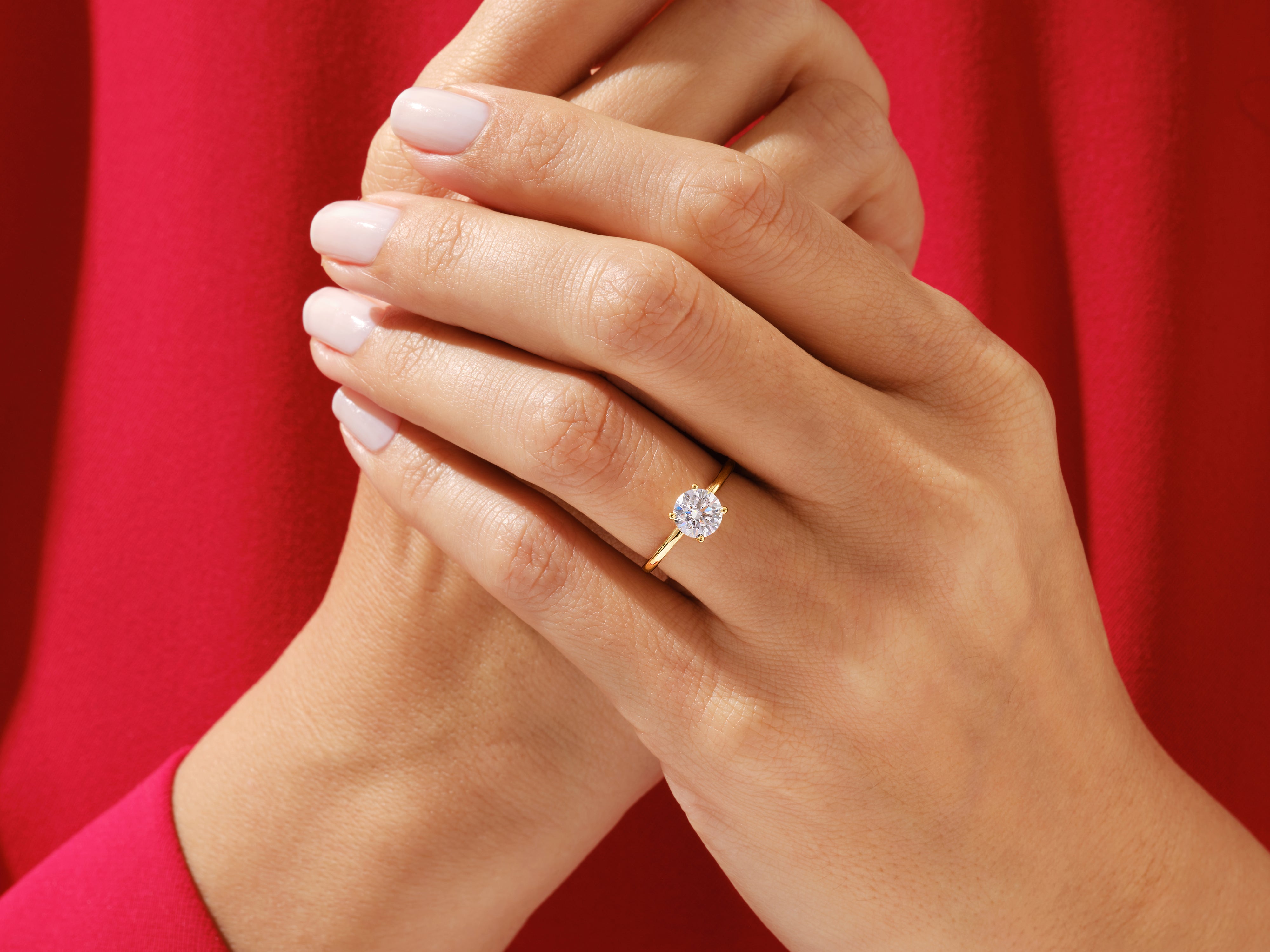 Diamond engagement ring on a hand, jewelry firm product