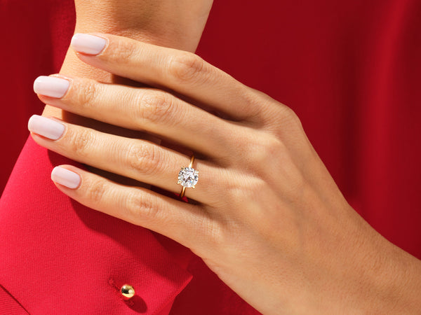 Diamond engagement ring on a hand, jewelry firm product