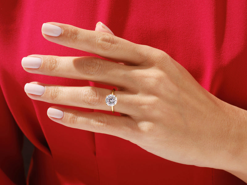 Diamond engagement ring on a woman's hand, jewelry product photography
