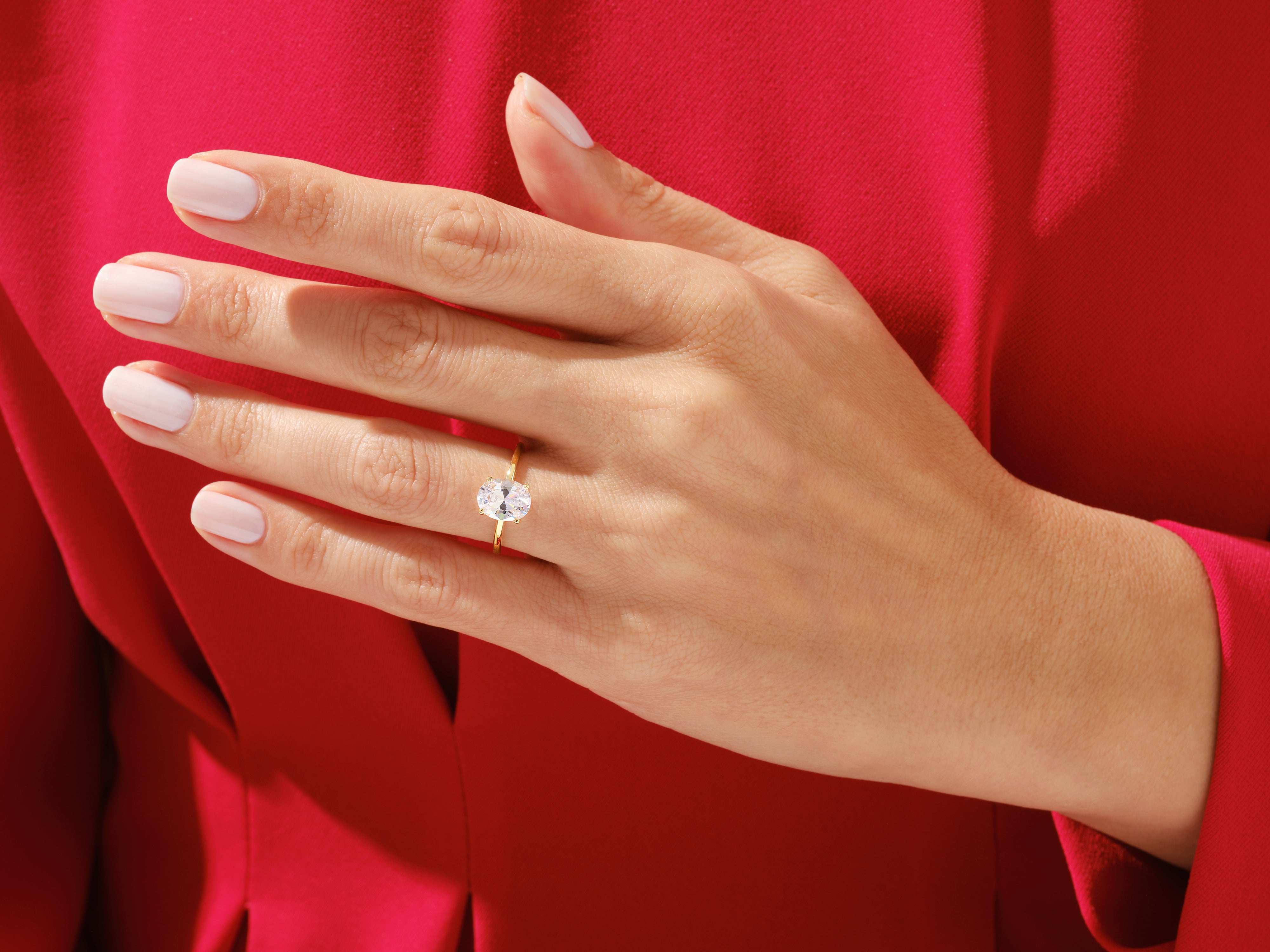 Oval diamond engagement ring on a hand, luxury jewelry