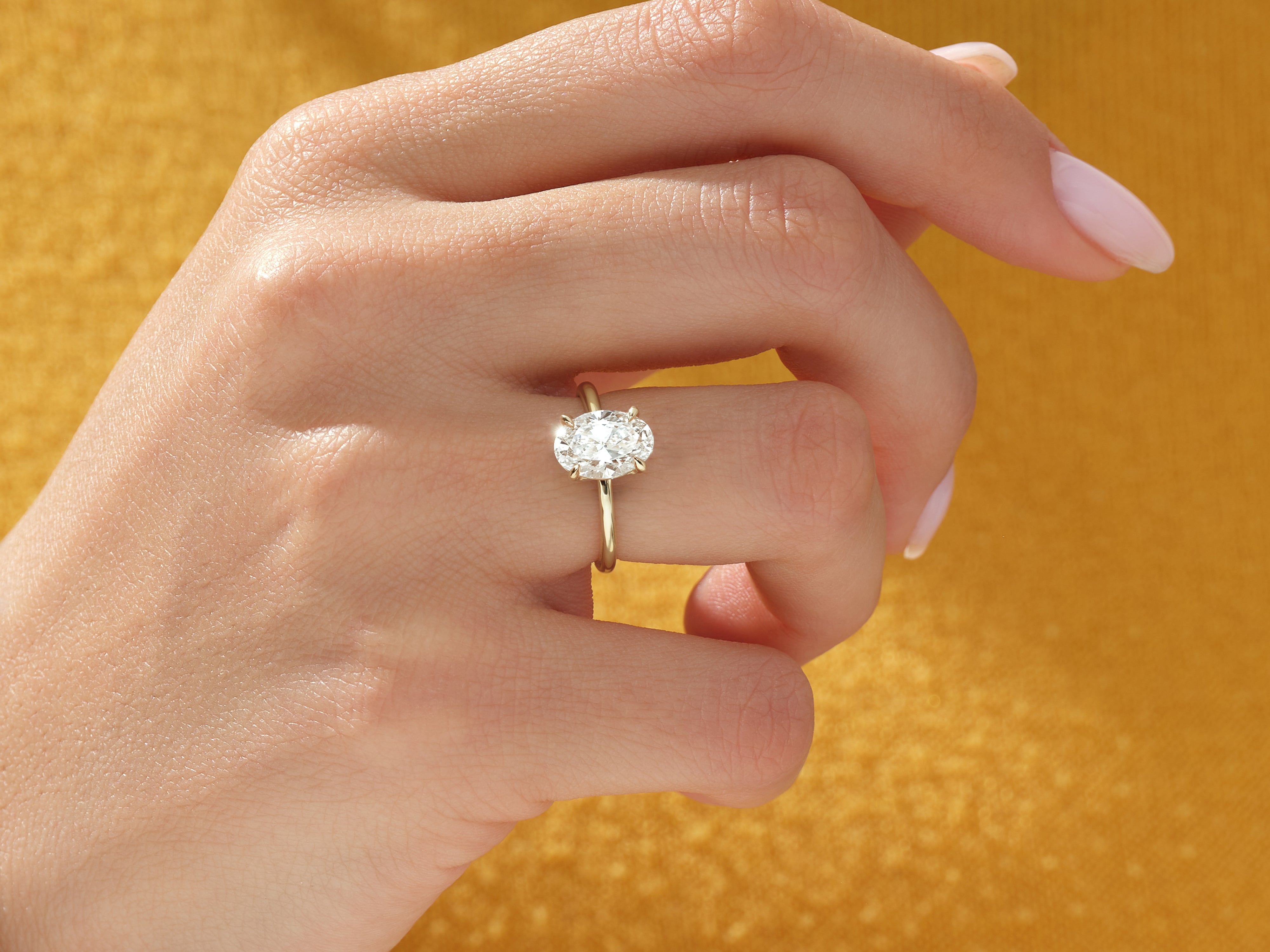 Oval diamond engagement ring on a woman's hand