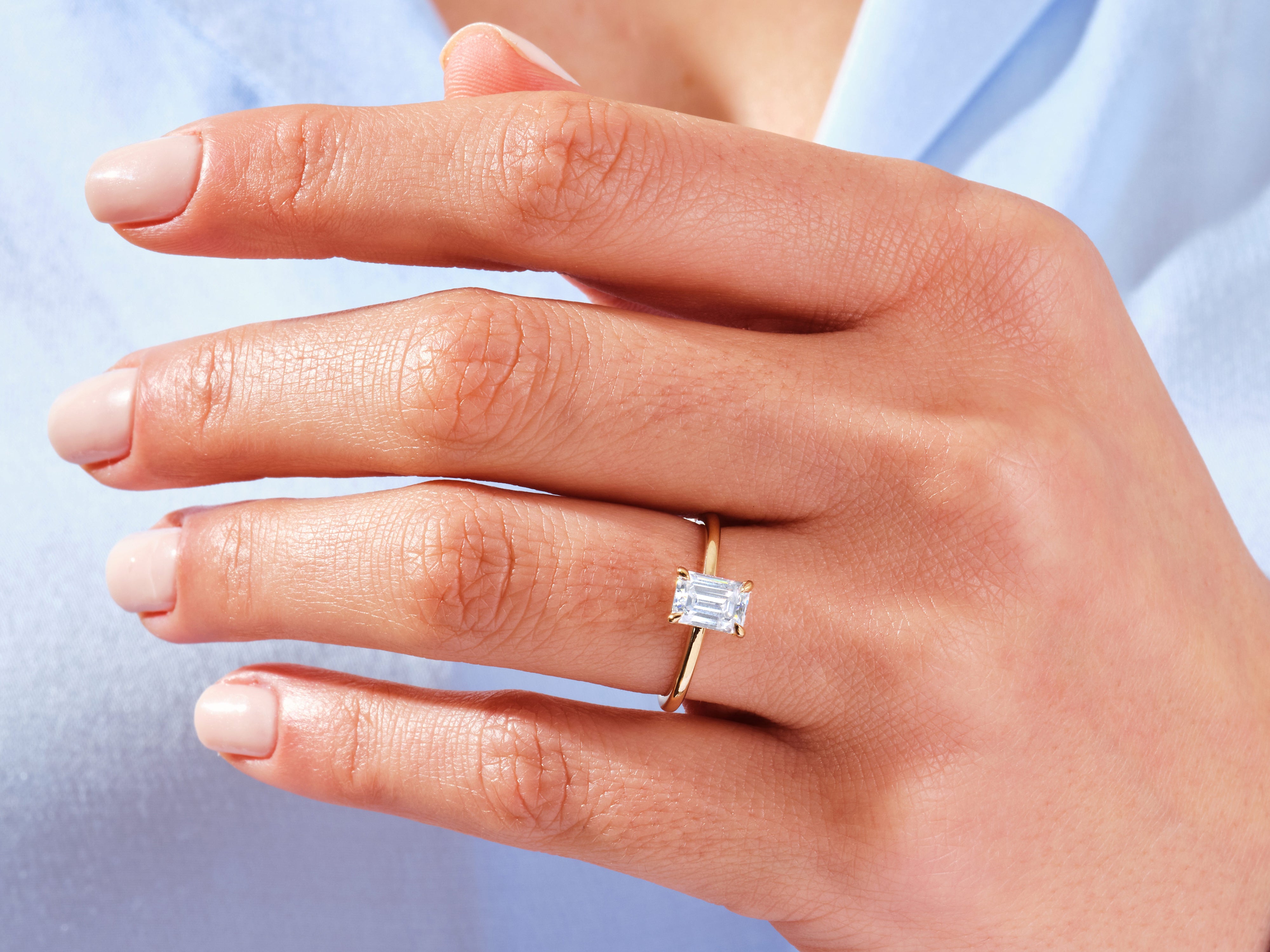 Emerald cut diamond ring on a woman's hand