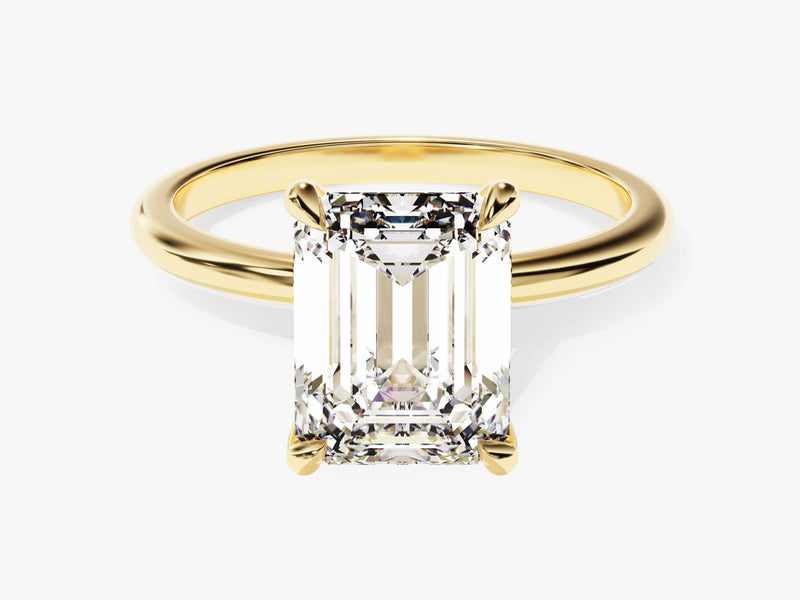 Emerald cut diamond ring in yellow gold setting