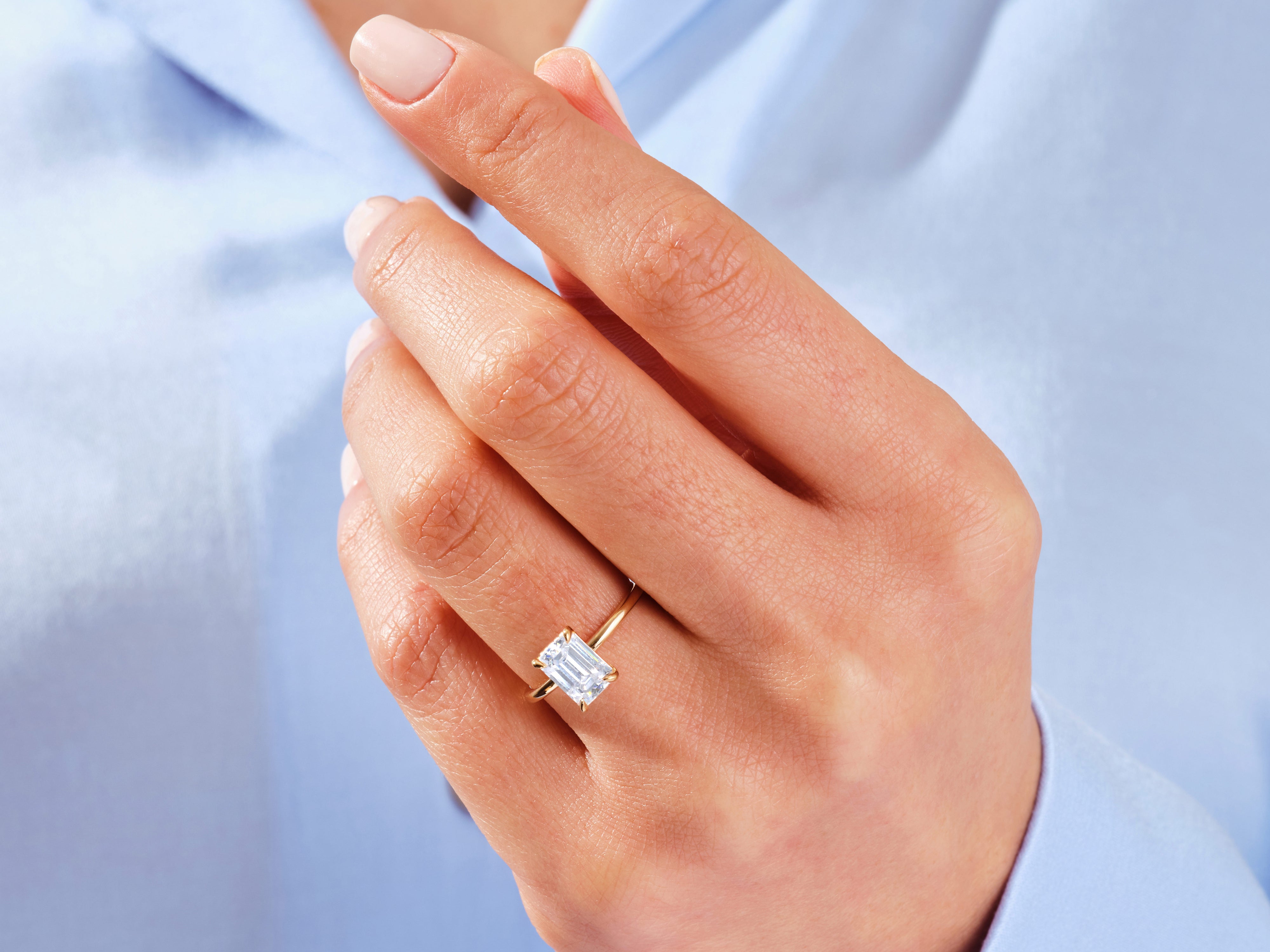 Emerald cut diamond ring on a woman's hand