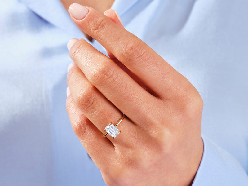 Emerald cut diamond ring on a woman's hand