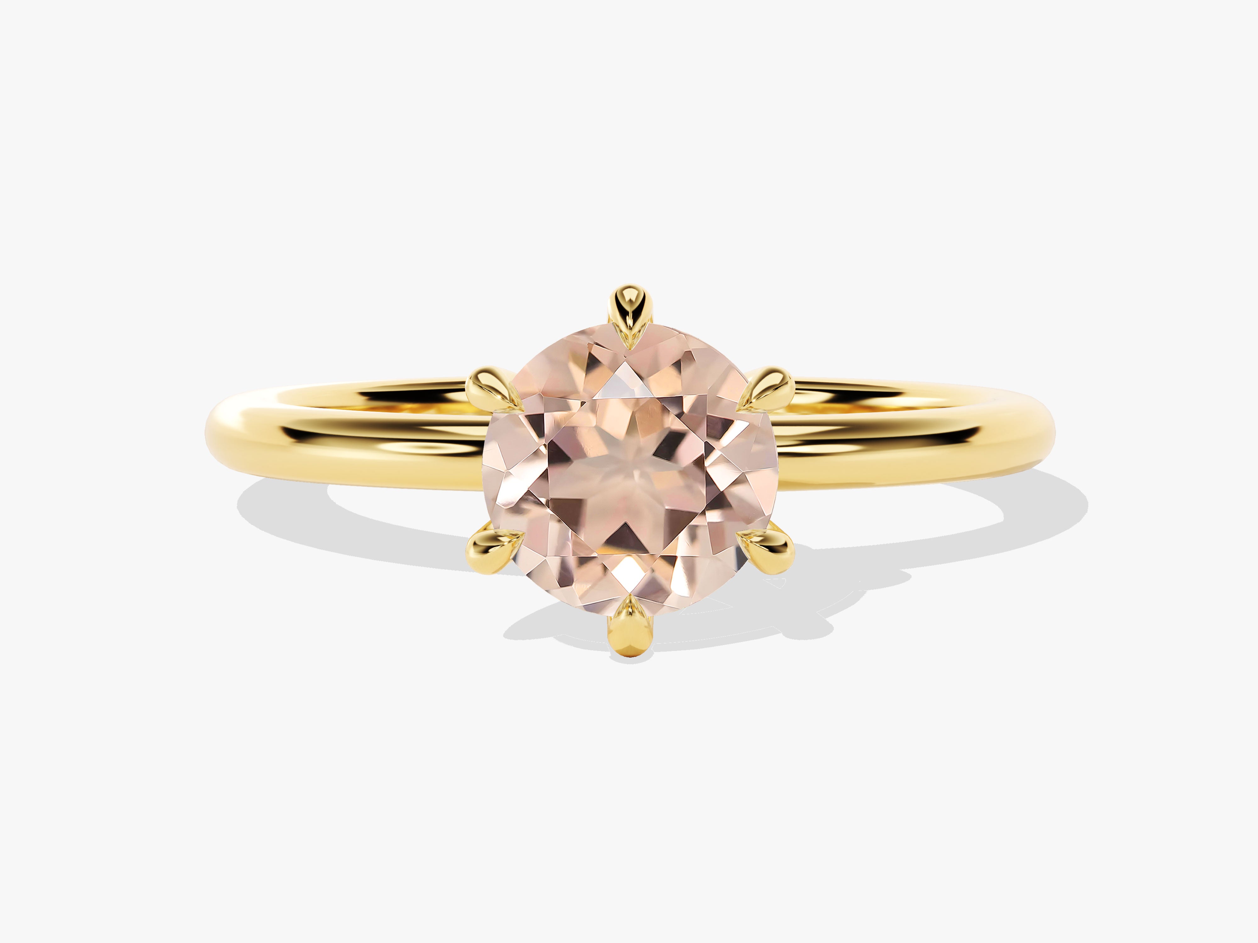 Gold ring with a large, faceted peach gemstone