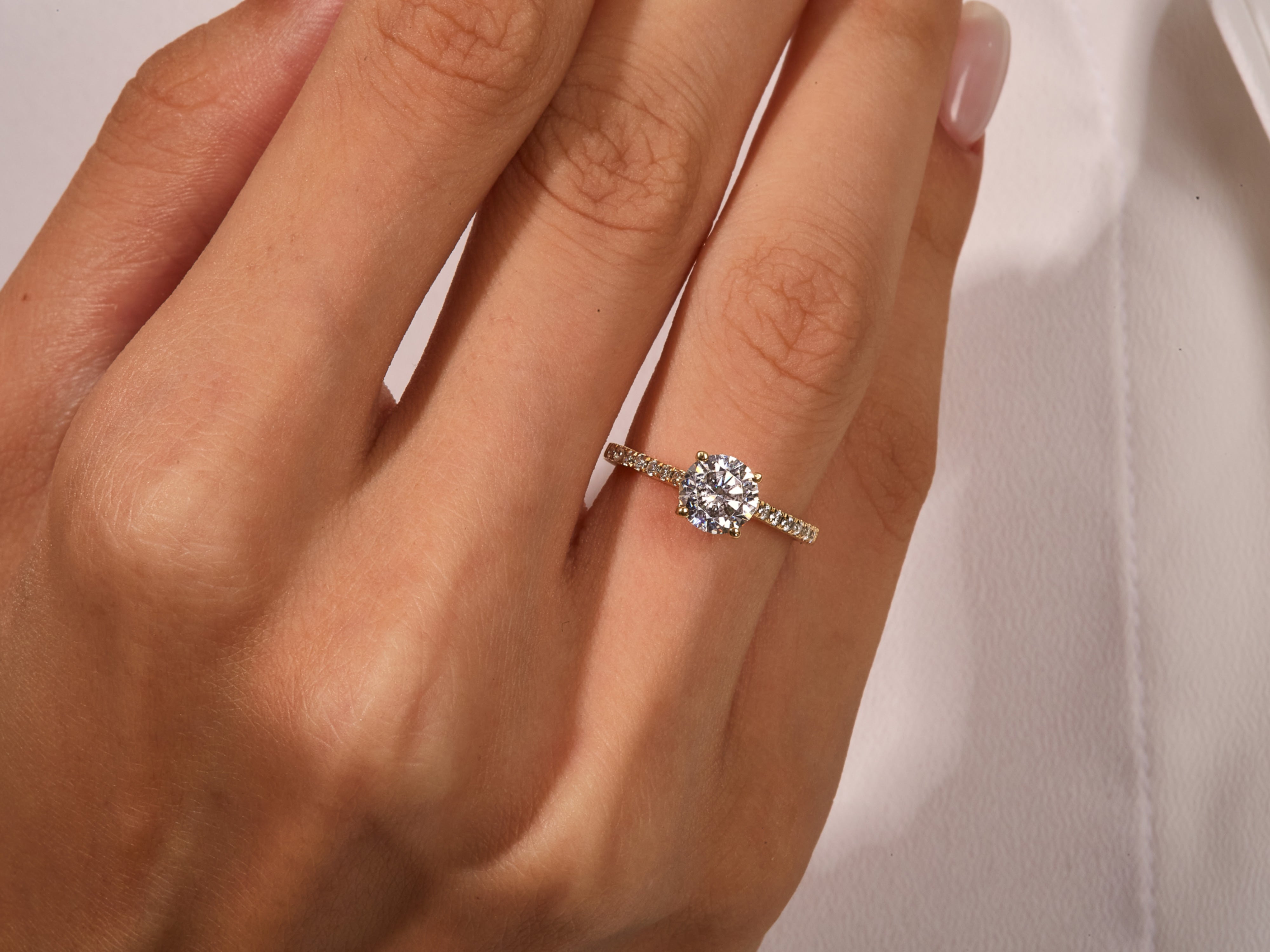 Diamond engagement ring on a hand, fine jewelry for her