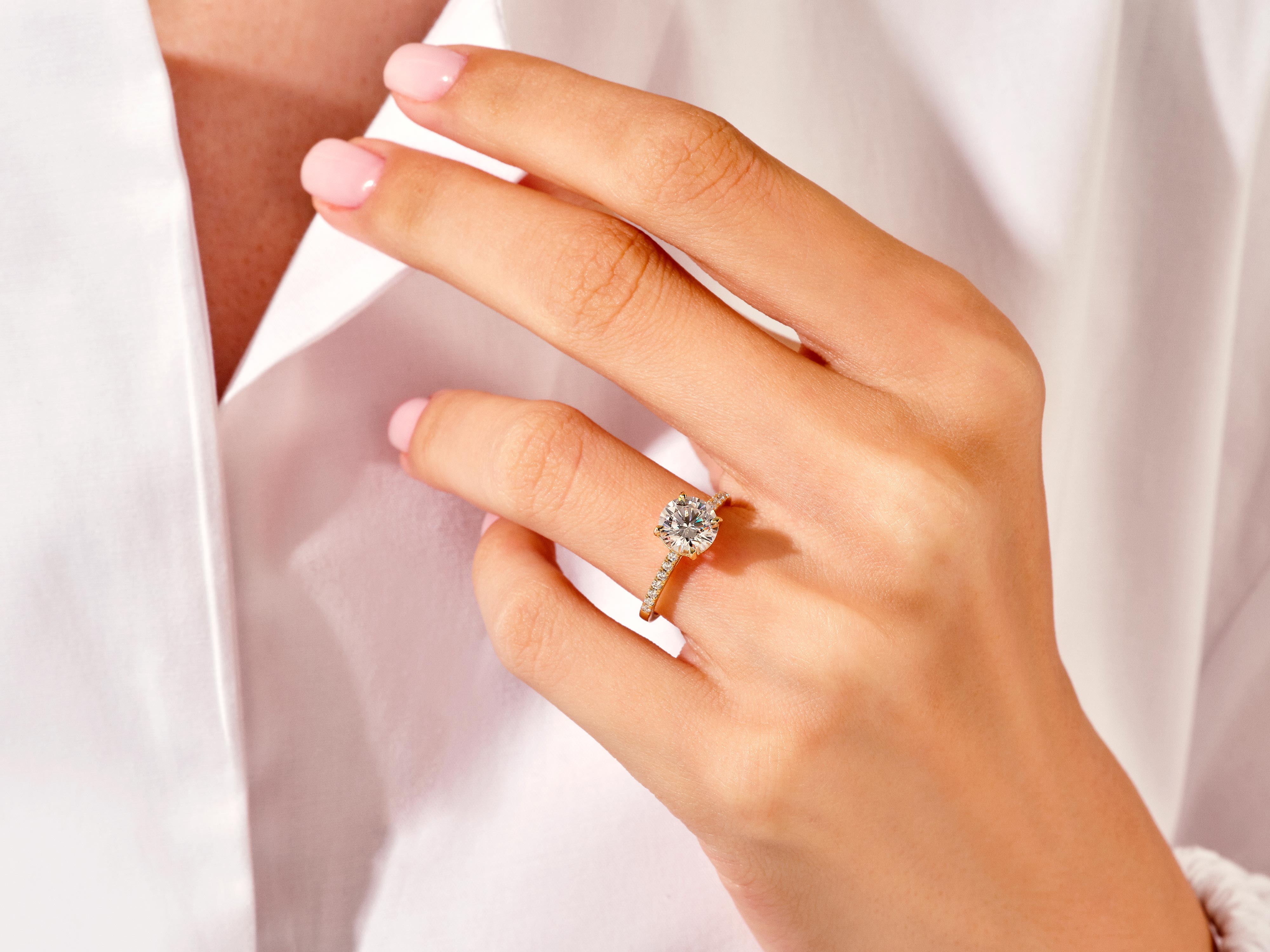 Diamond engagement ring on a woman's hand, jewelry product