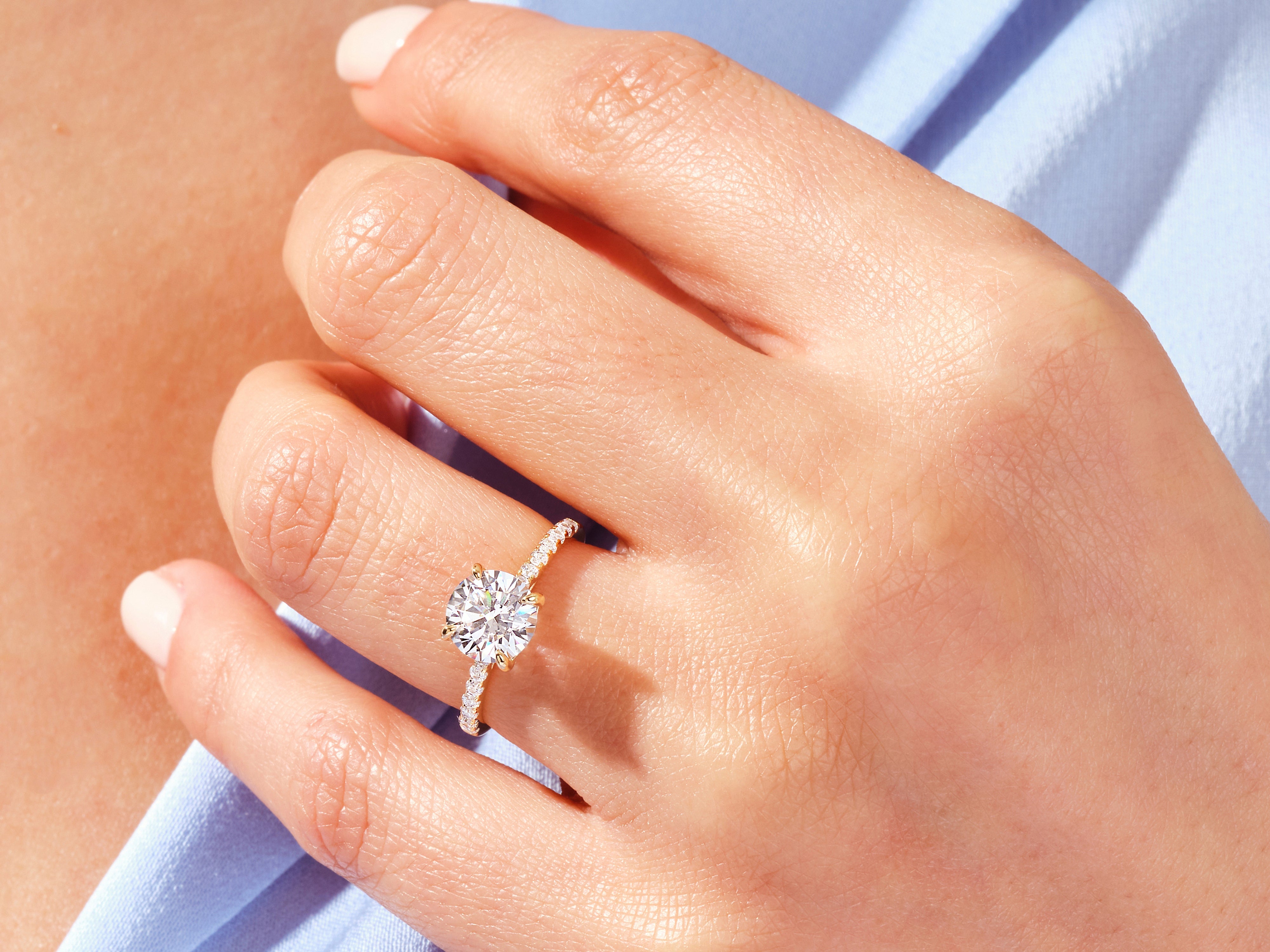 Diamond engagement ring on a woman's finger, luxury jewelry