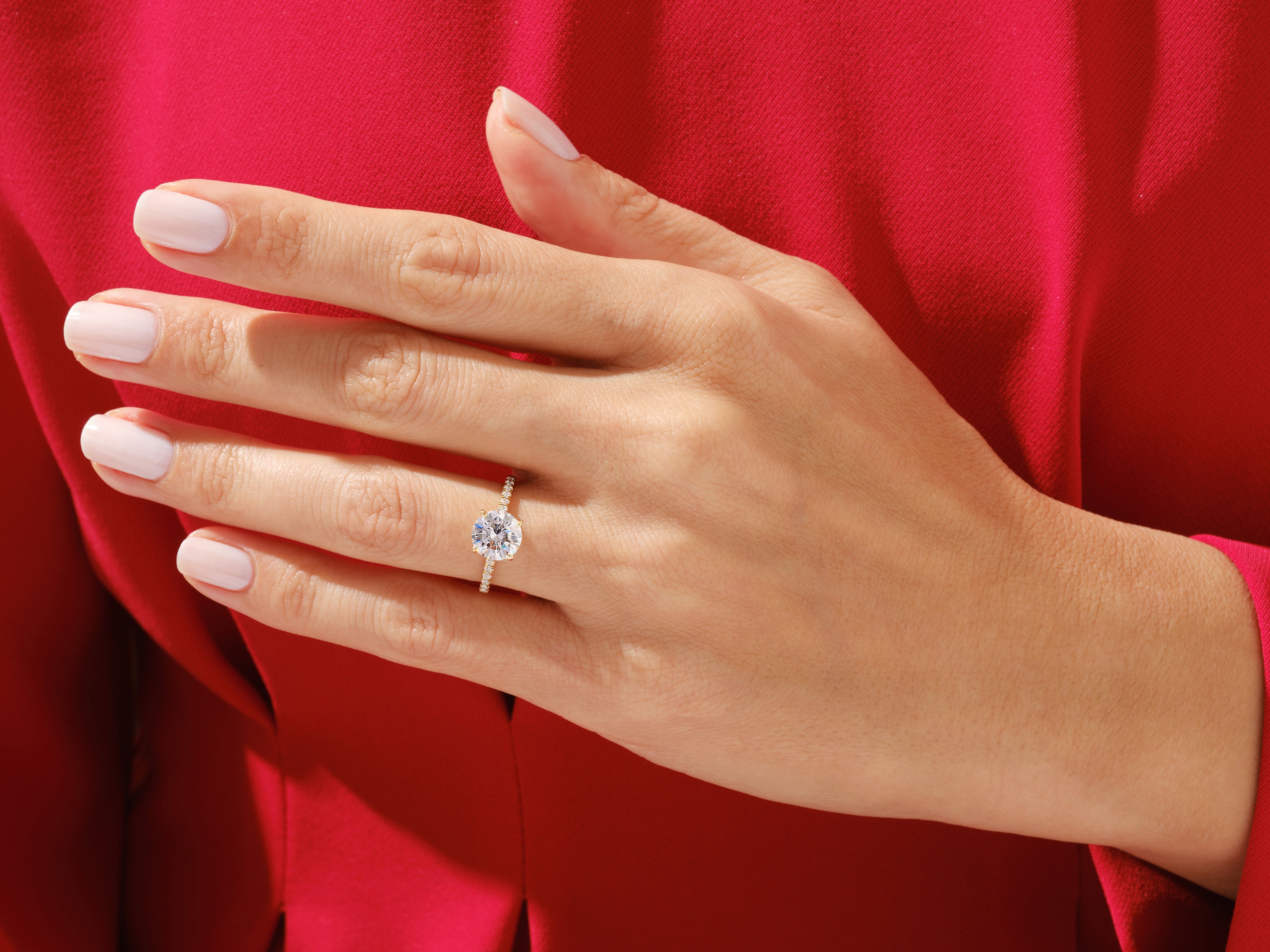 Diamond engagement ring on hand, jewelry product photography