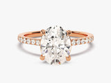 Oval diamond engagement ring with rose gold band and pave diamonds