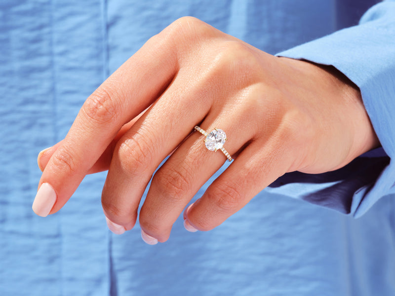 Oval diamond engagement ring on a hand, jewelry