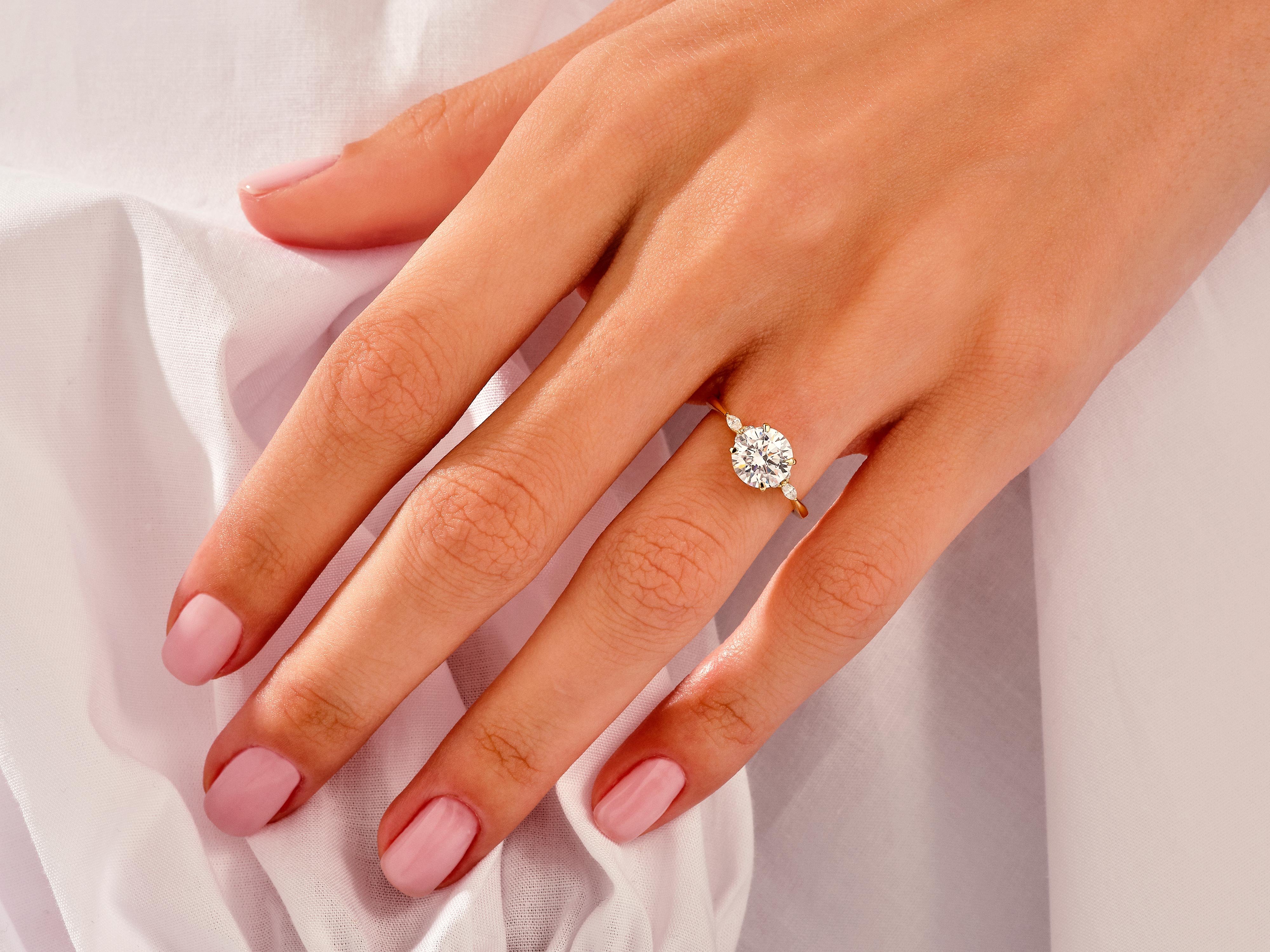 Gold diamond engagement ring on a woman's hand
