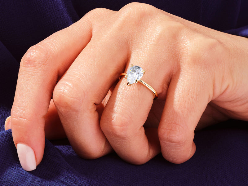 Pear cut diamond ring on hand, fine jewelry