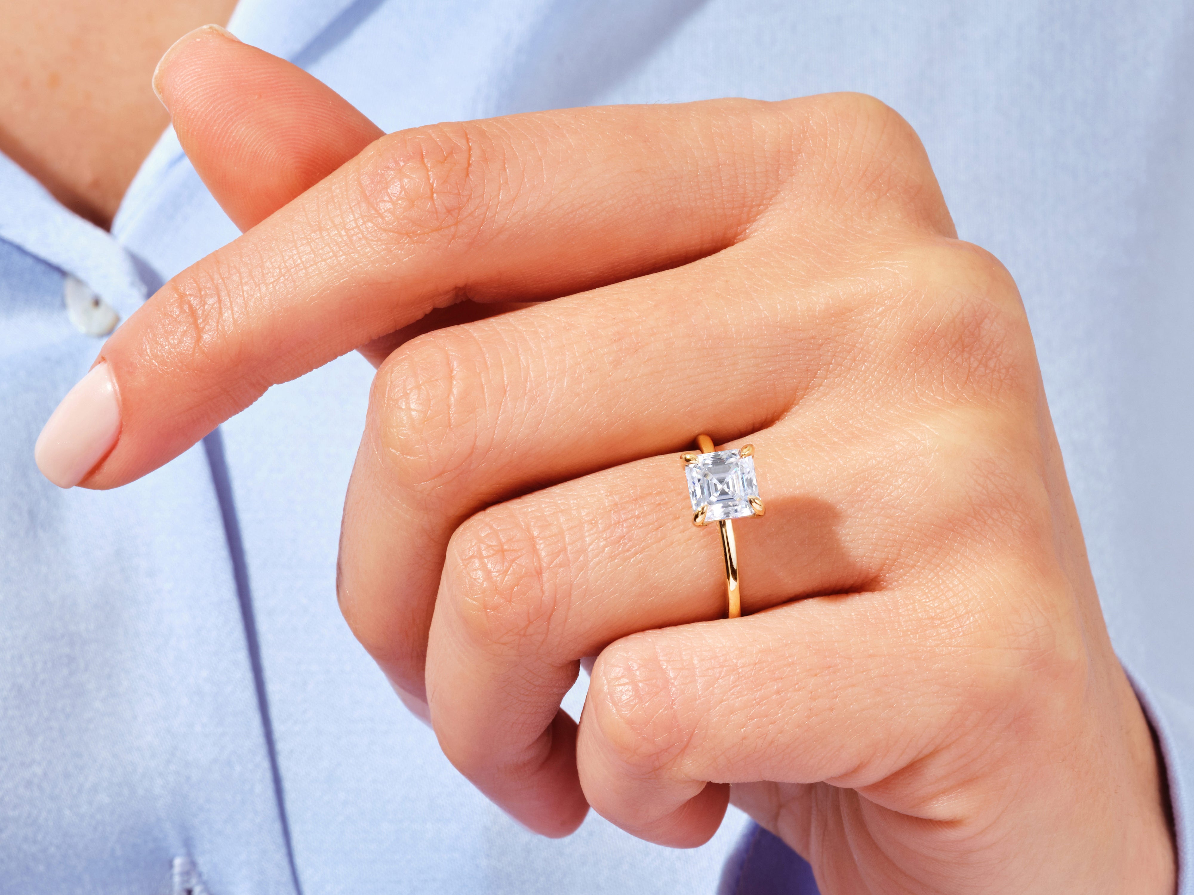Emerald cut diamond ring on a gold band, jewelry