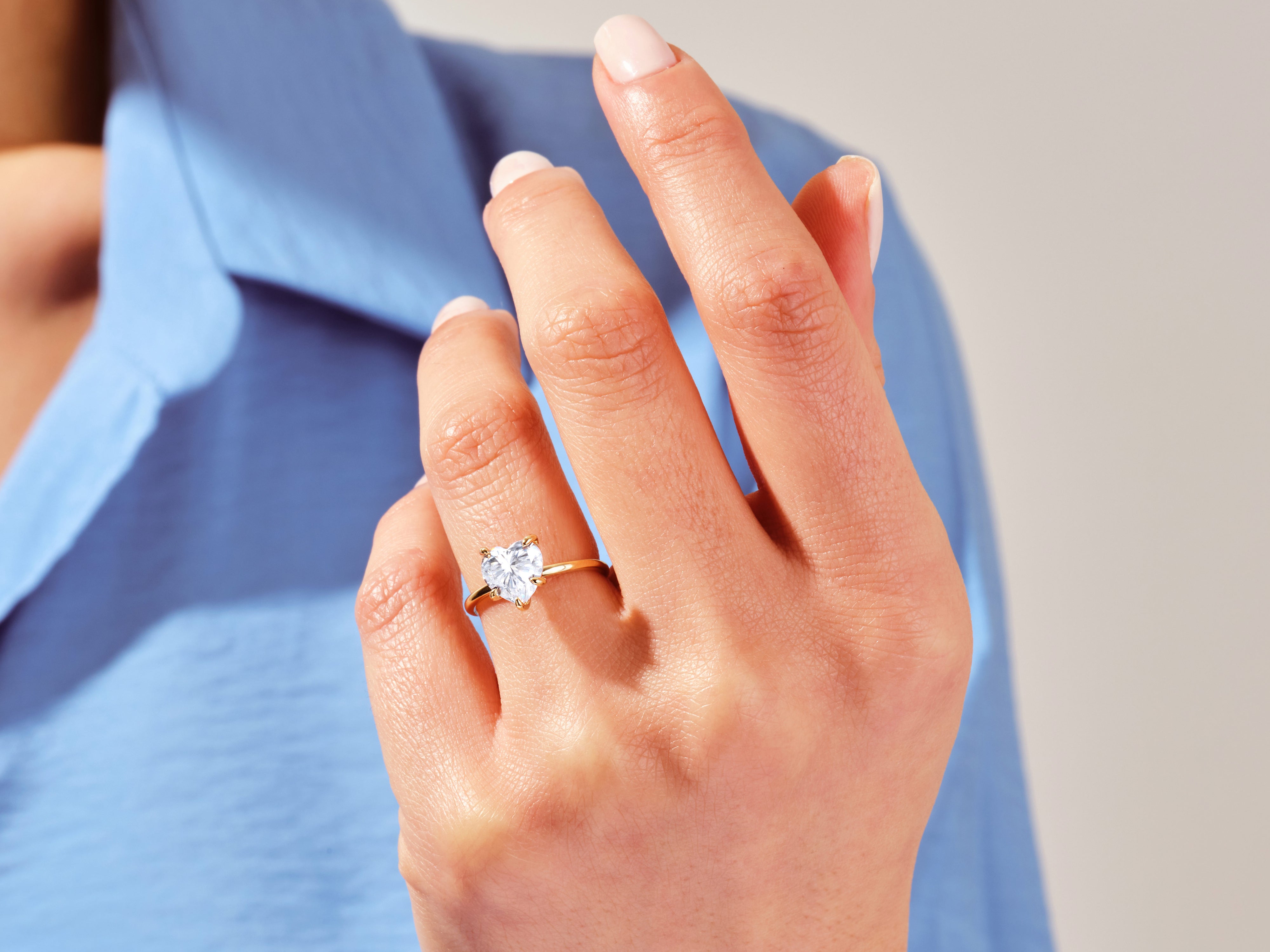 Gold heart diamond ring on a woman's finger