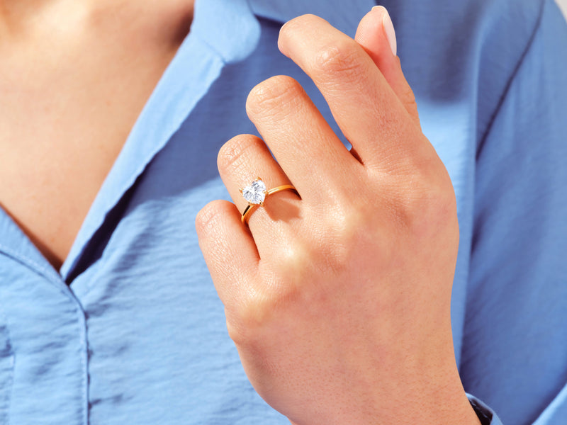Heart-shaped diamond ring on a woman's hand, jewelry