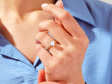 Gold heart diamond ring on a woman's finger
