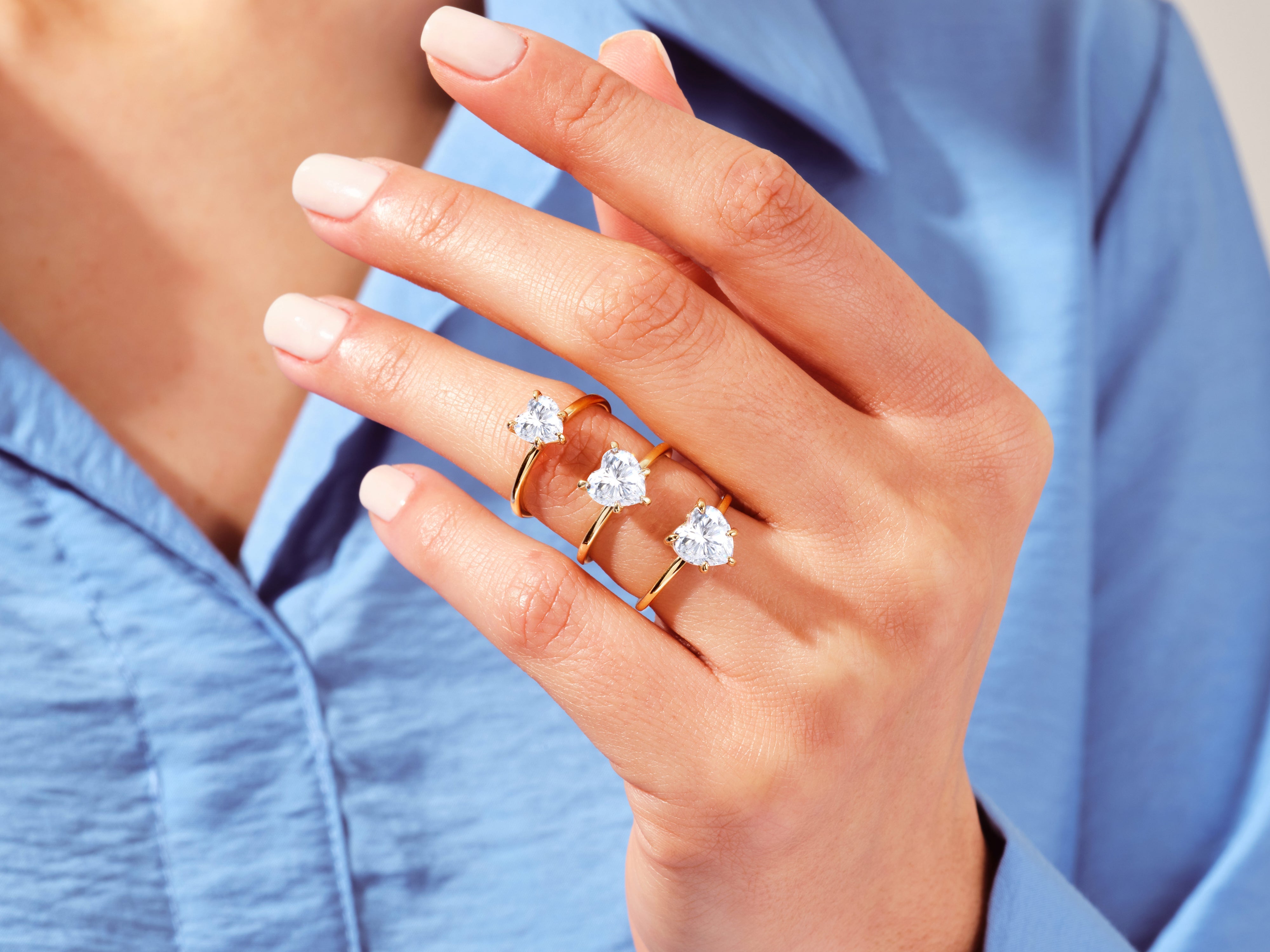 Gold heart diamond rings on hand, jewelry collection