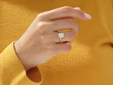 Gold ring with radiant cut diamond on hand