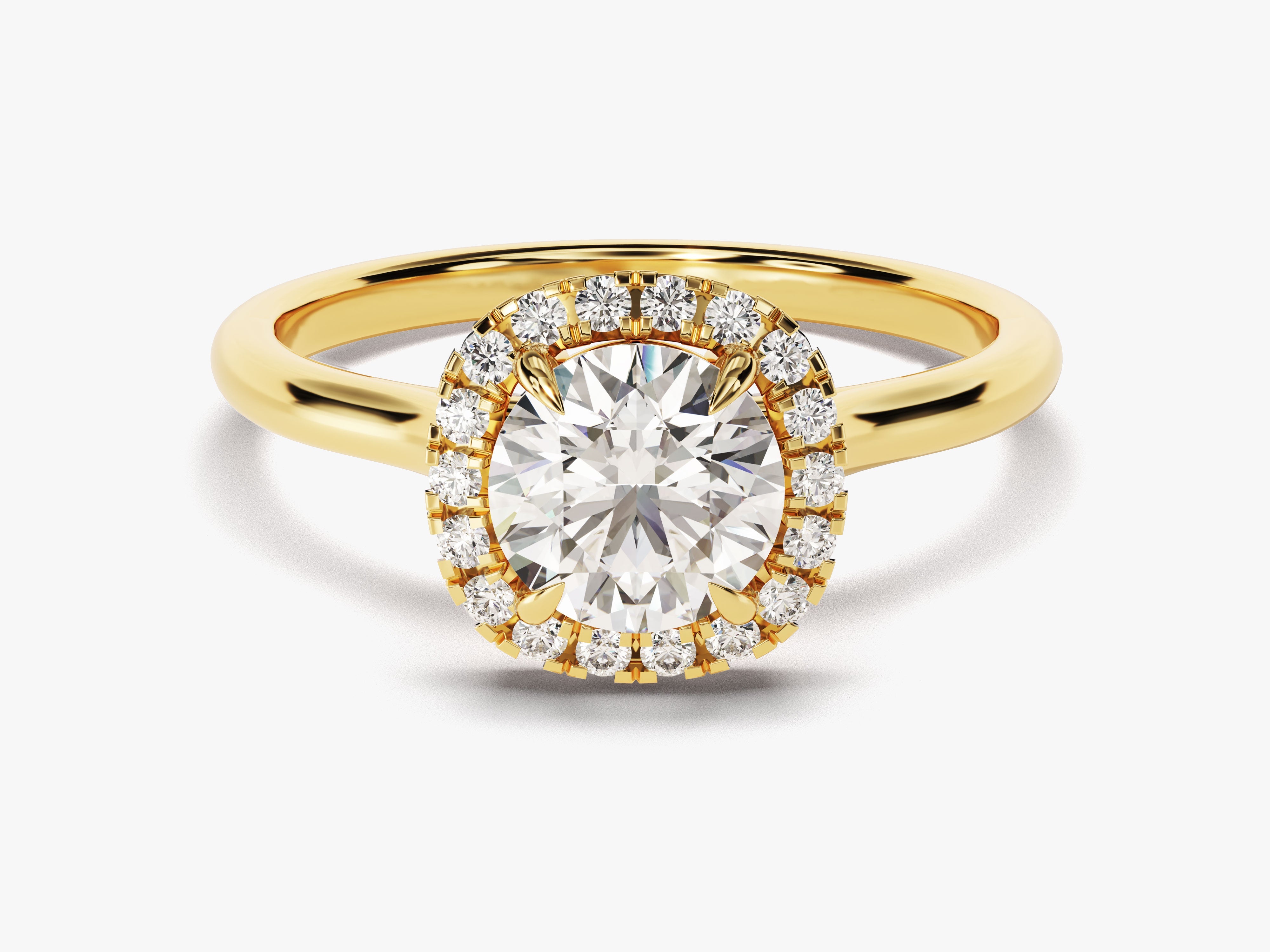Oval diamond halo engagement ring in yellow gold