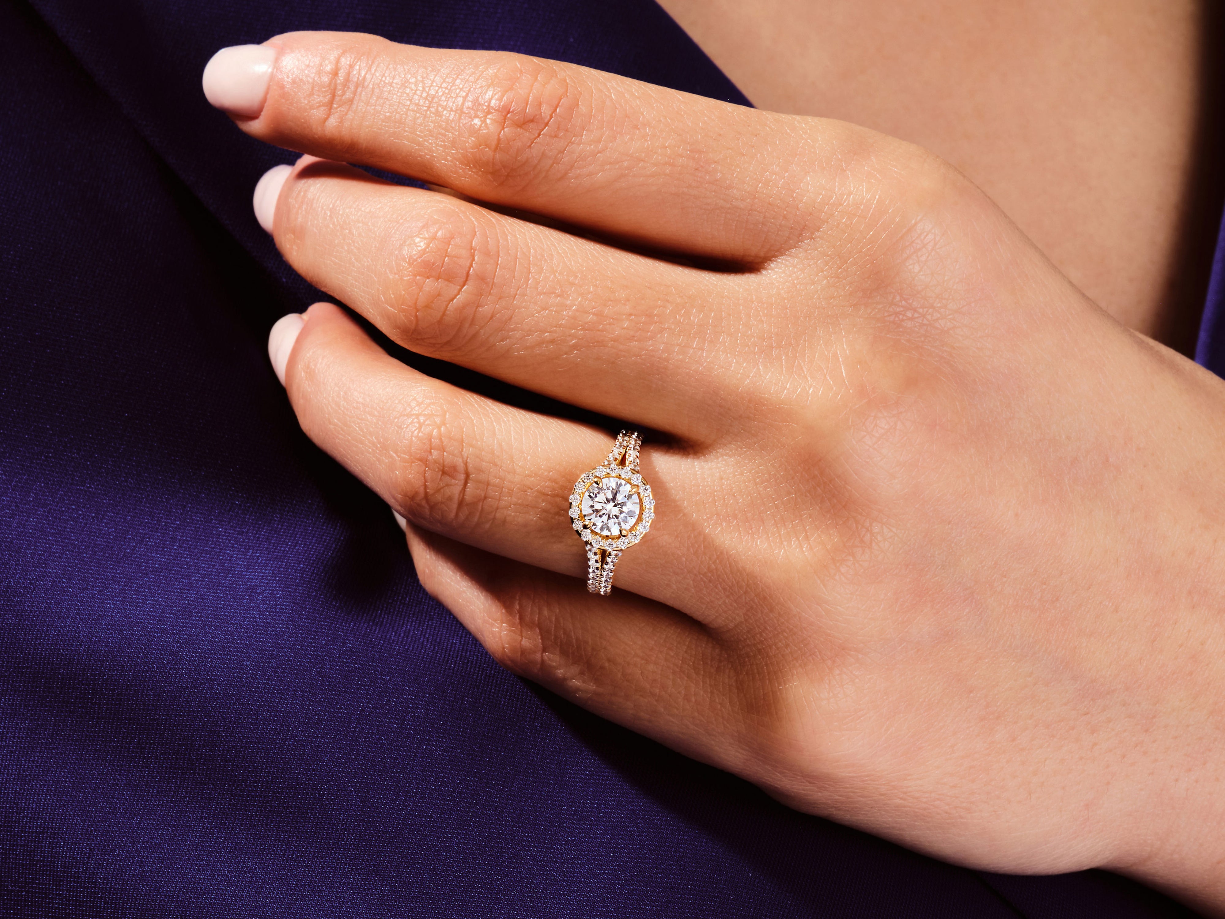 Diamond halo engagement ring on a hand, luxury jewelry