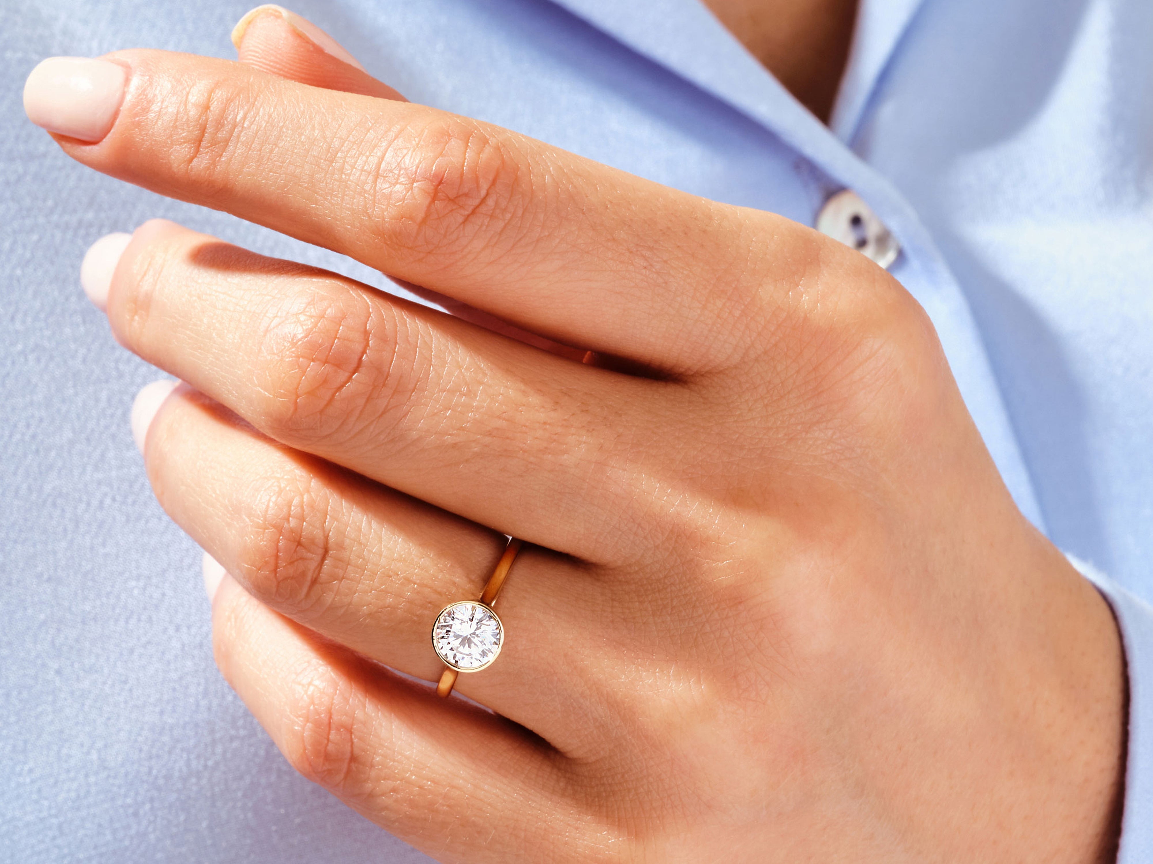 Gold diamond ring on a woman's hand, jewelry product photography