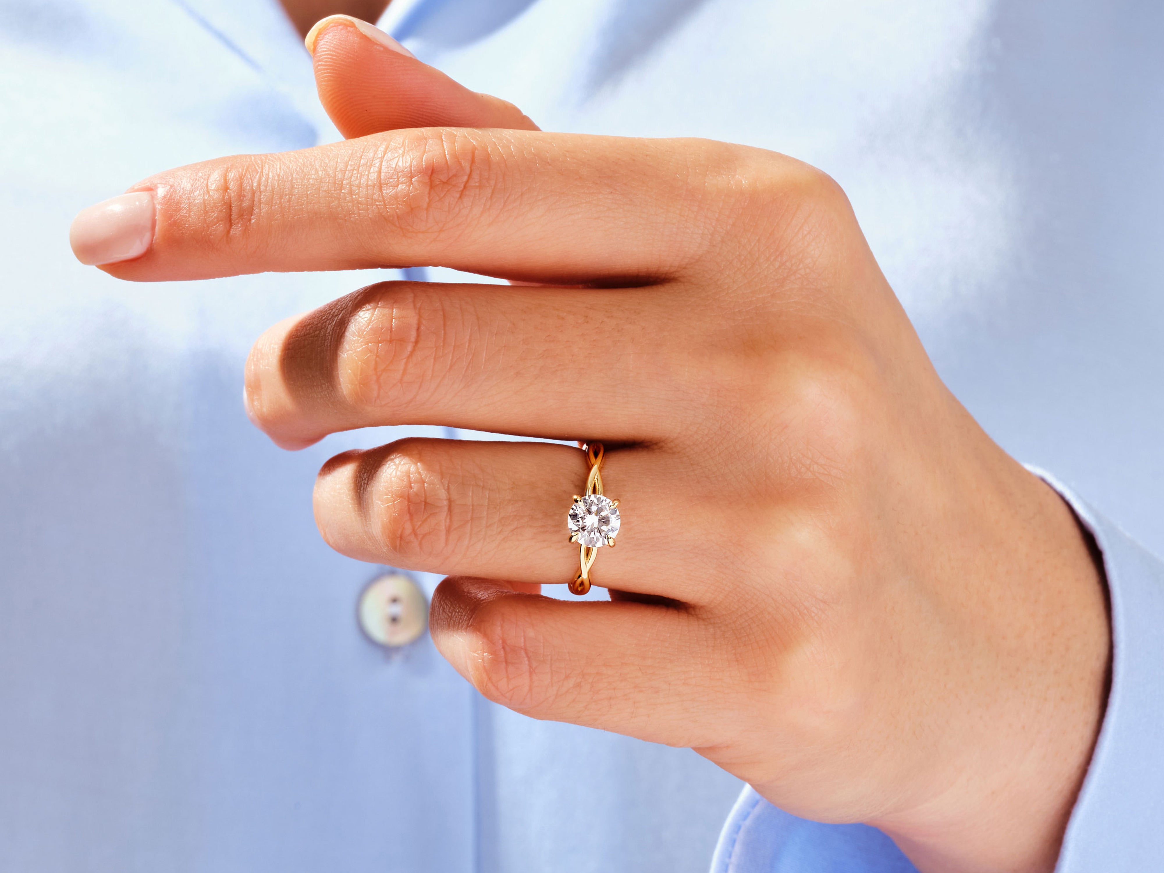Gold diamond ring on a woman's finger, jewelry
