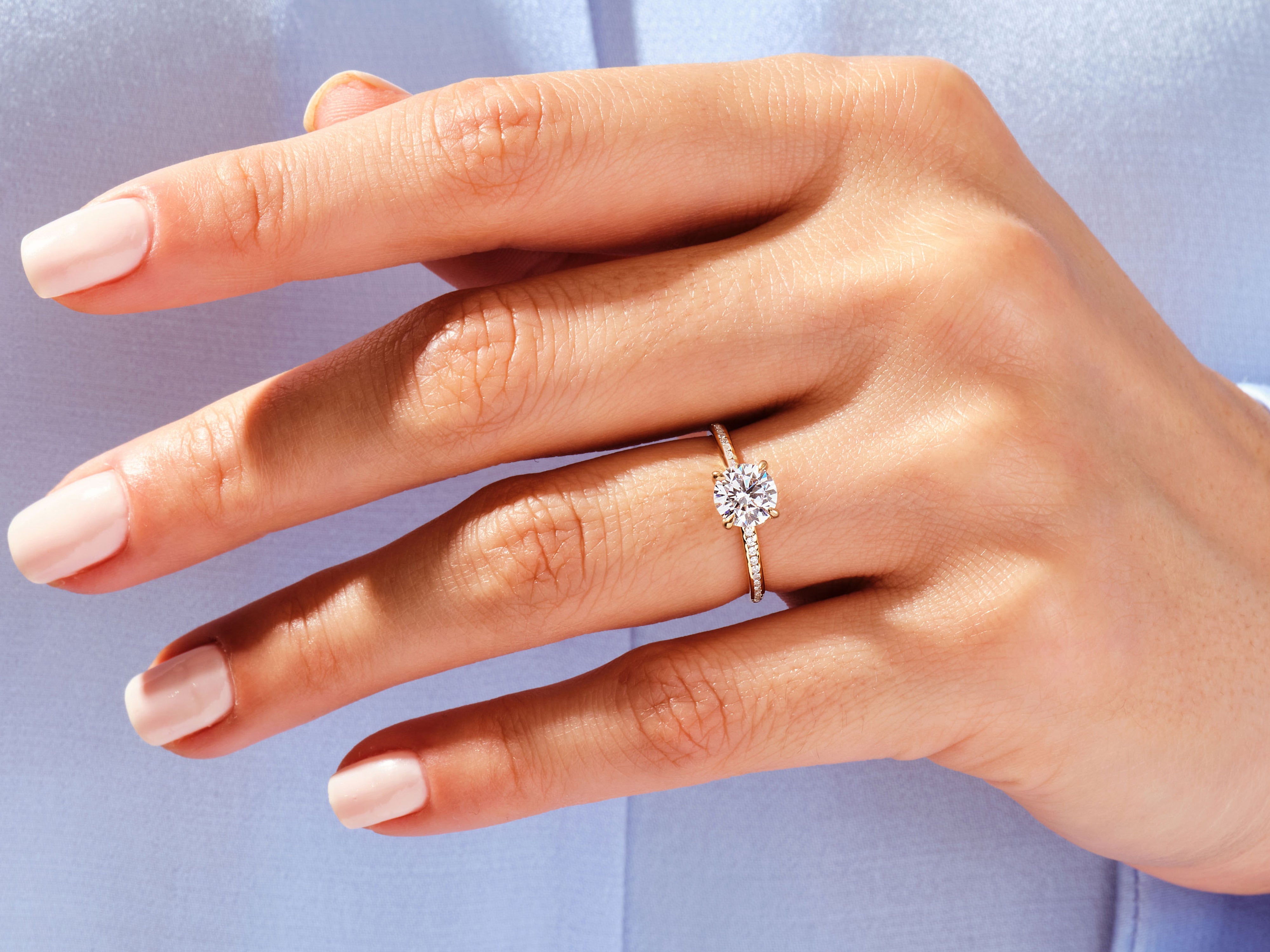Diamond engagement ring on a woman's hand, jewelry product photography