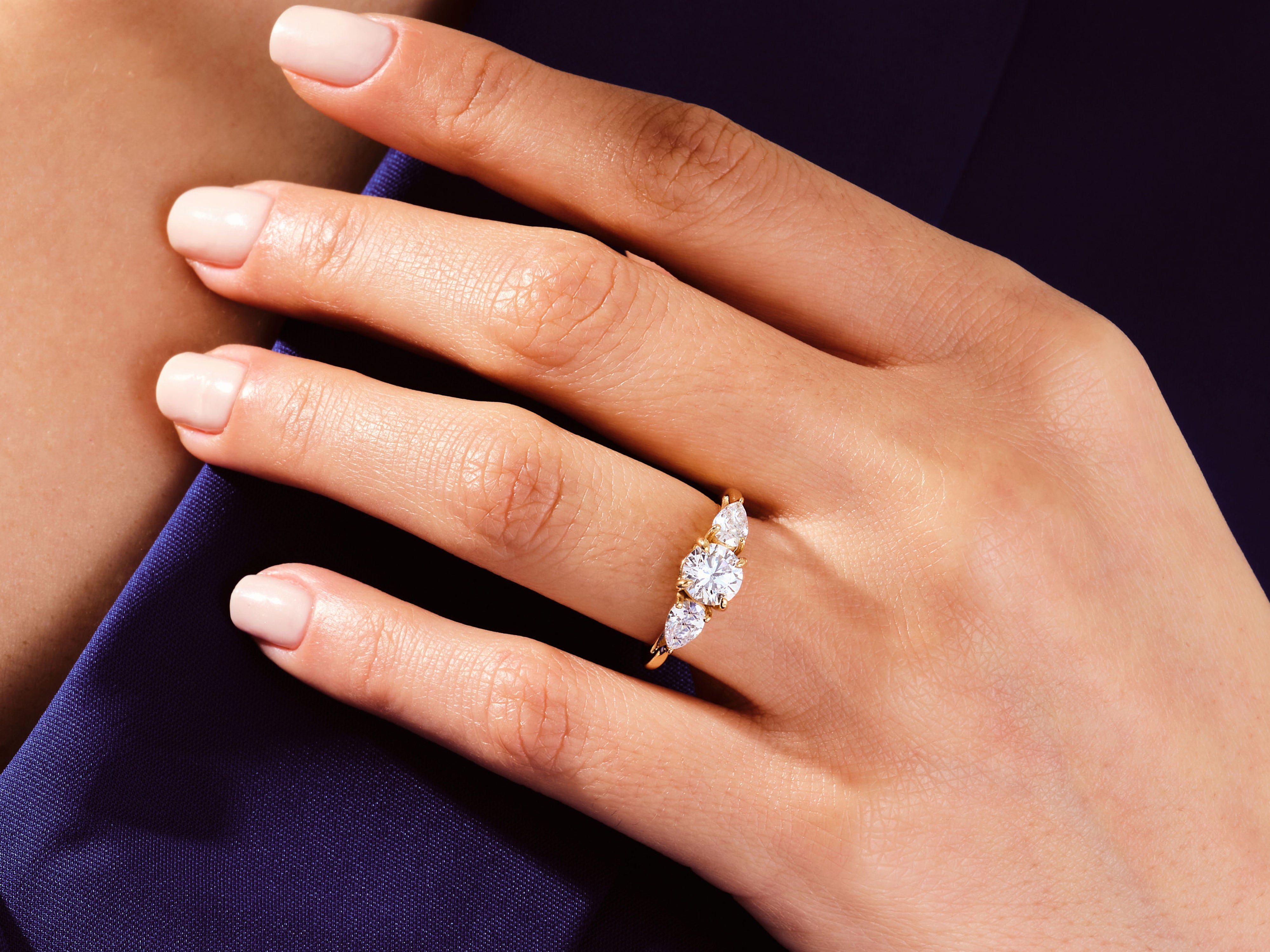 Gold diamond ring on a woman's hand, jewelry product photography