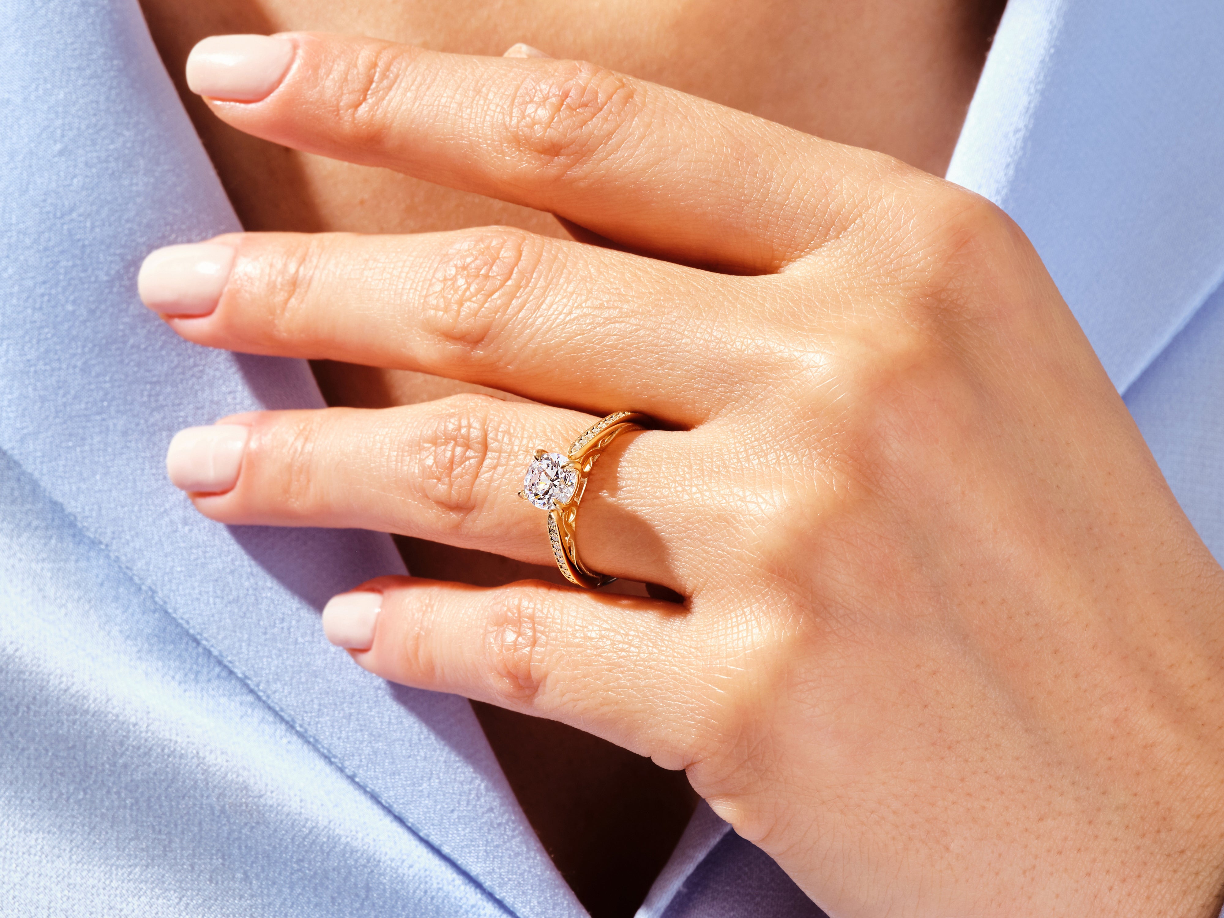 Gold diamond ring on a woman's hand, showcasing fine jewelry craftsmanship