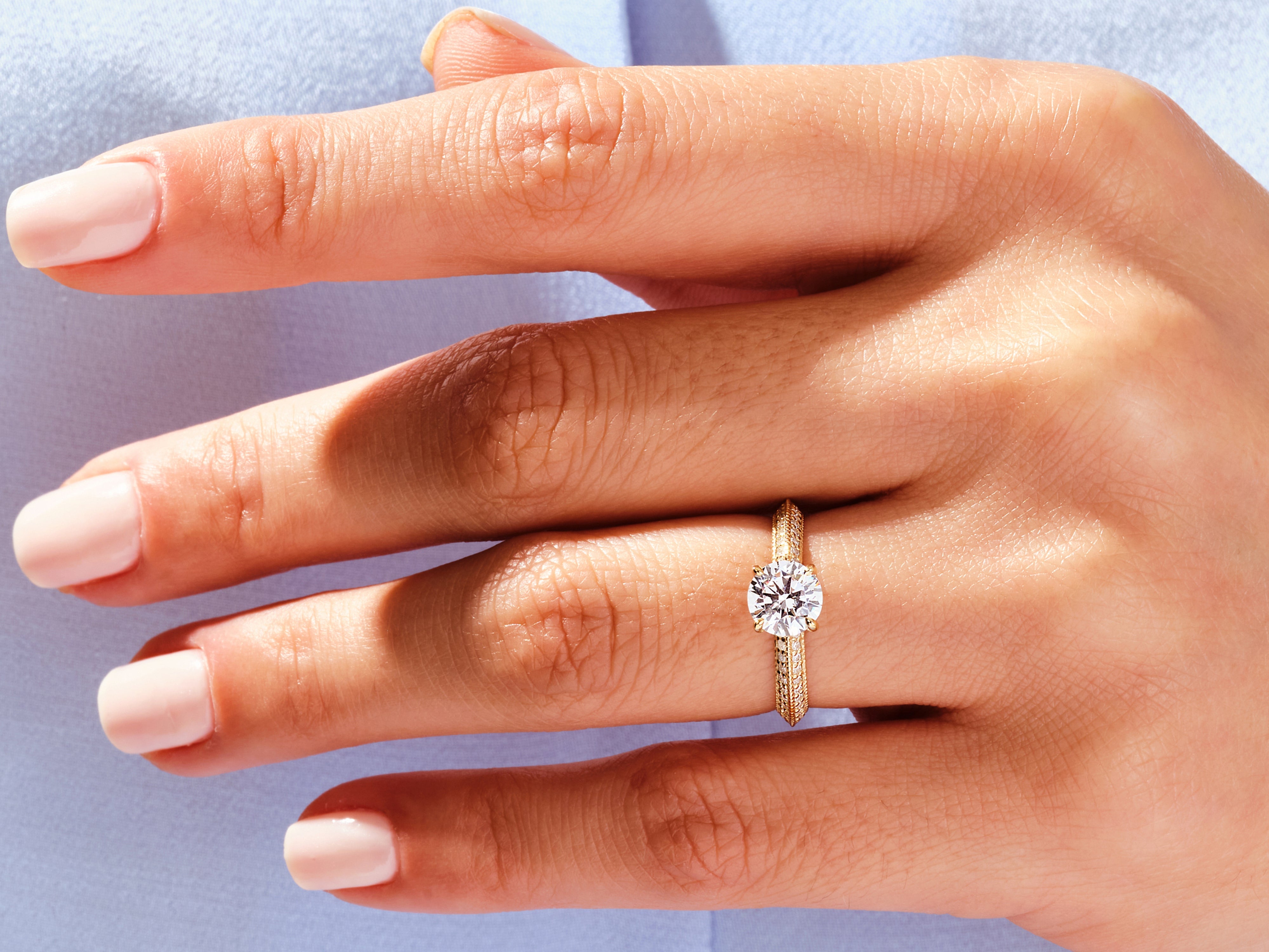 Diamond engagement ring on a hand, fine jewelry, luxury wedding ring