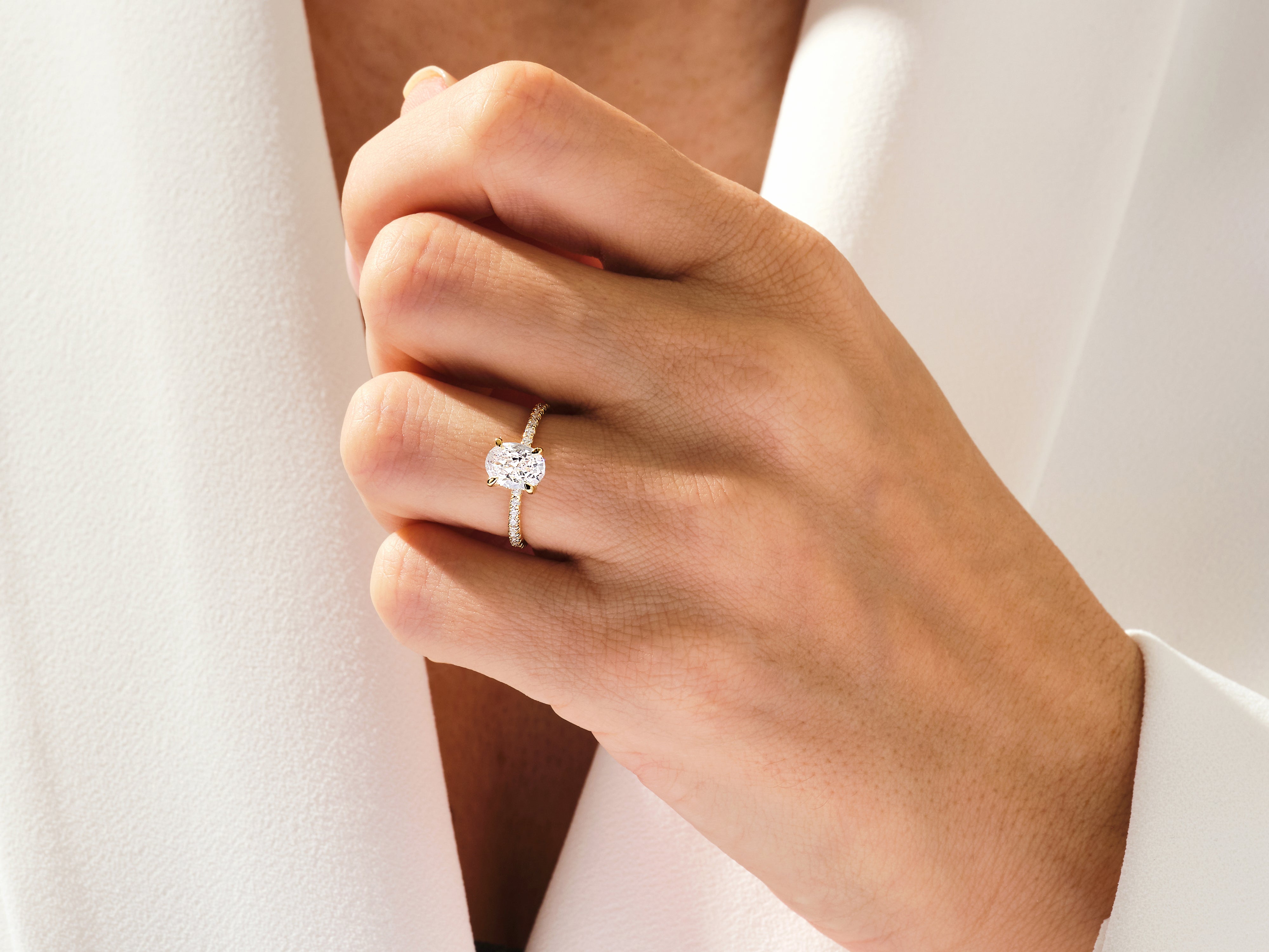 Oval diamond engagement ring on a hand, fine jewelry