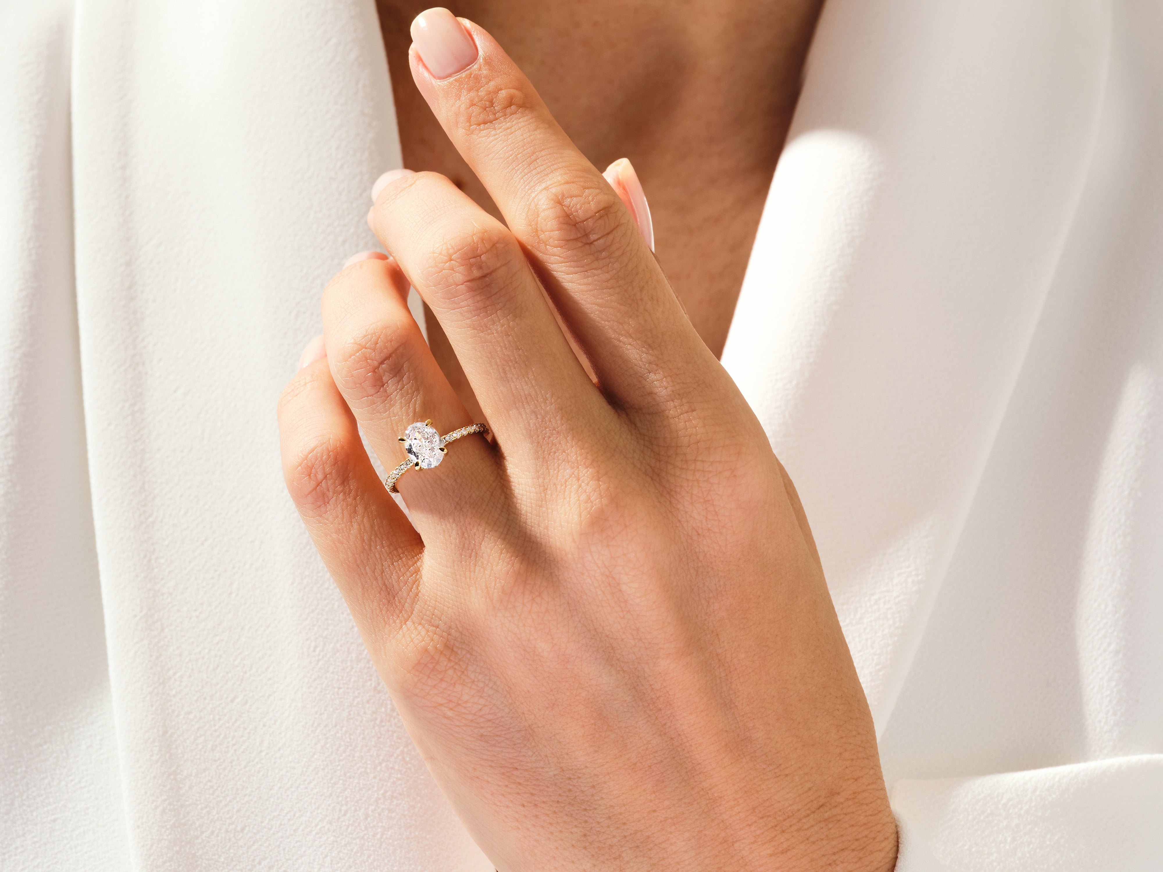 Oval diamond engagement ring on a woman's hand