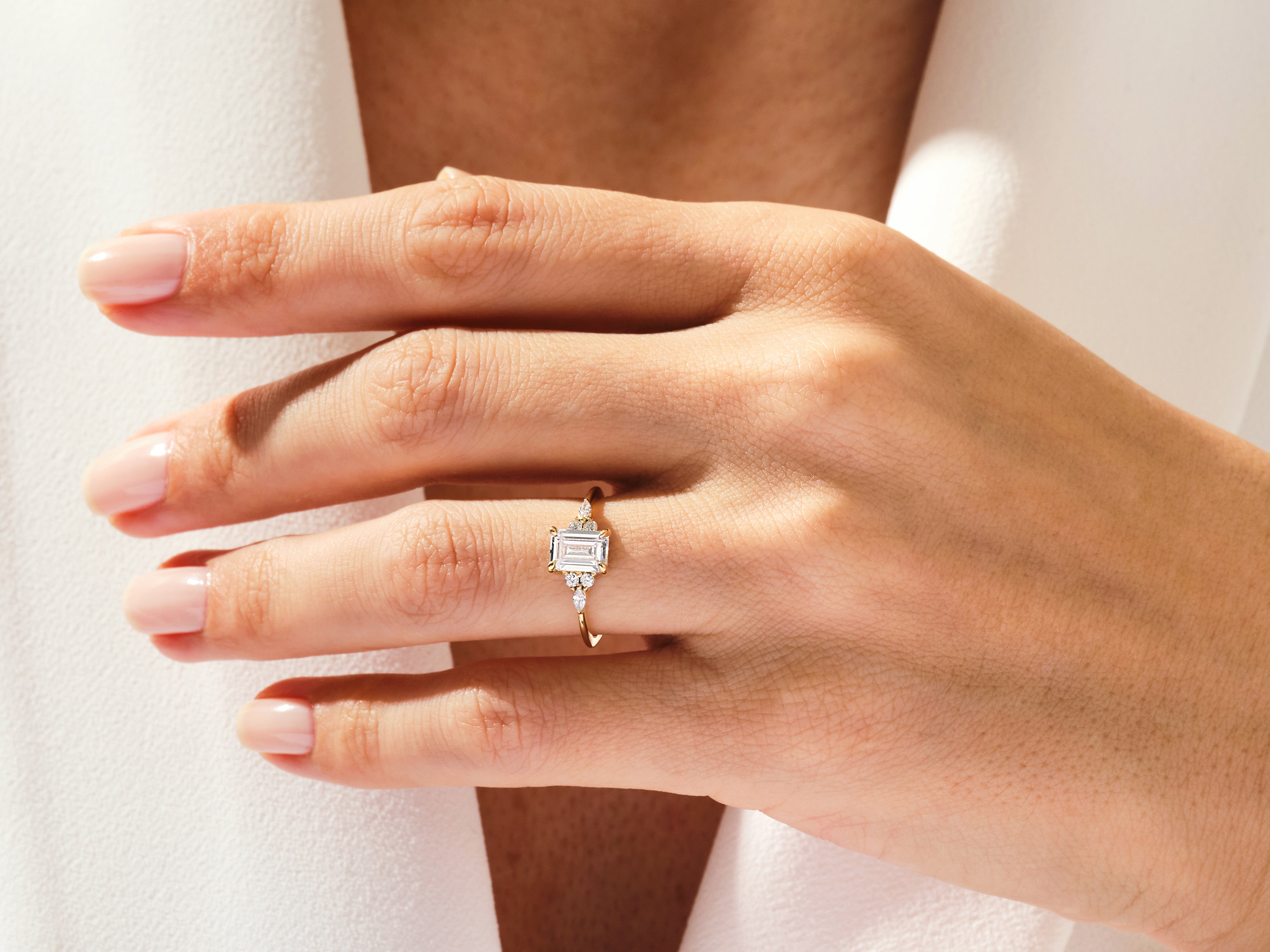 Emerald cut diamond ring on a hand, fine jewelry