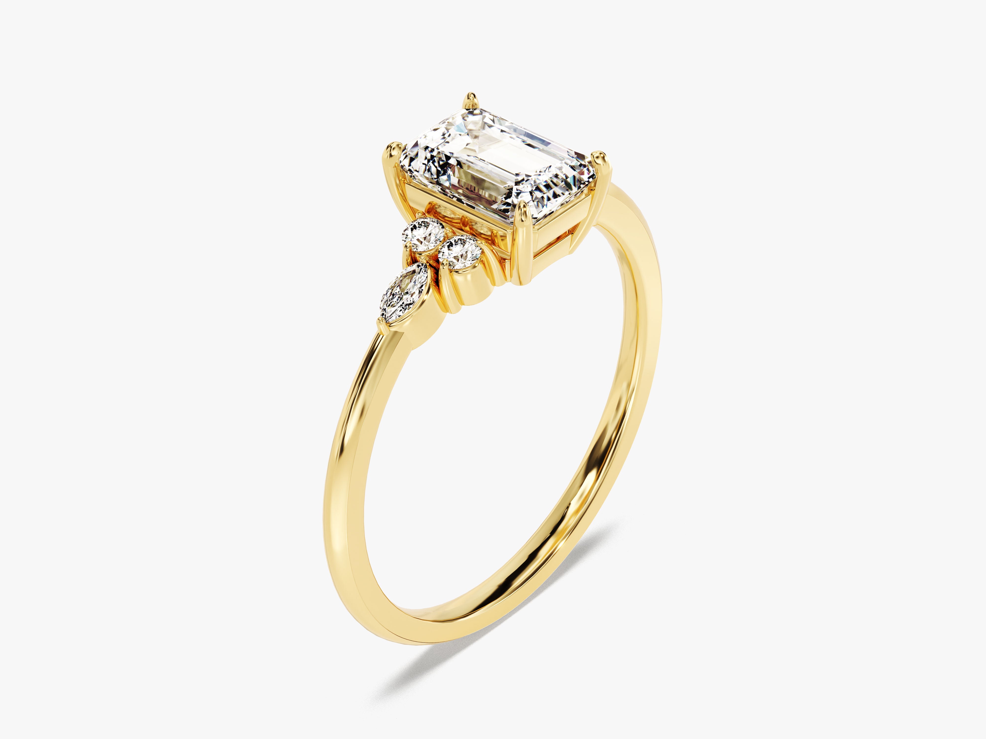 Emerald cut diamond ring with accent stones on yellow gold band