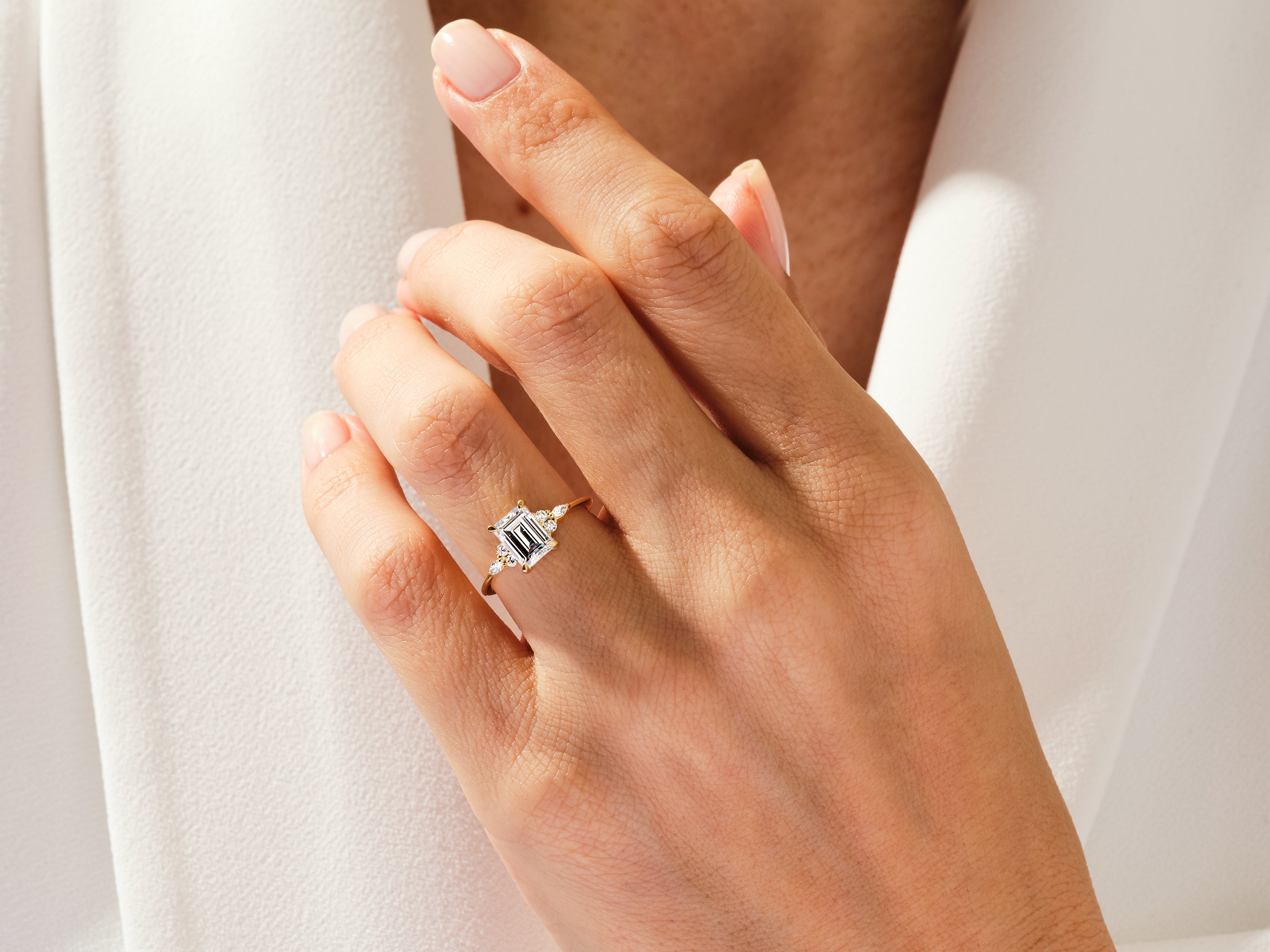 Emerald cut diamond ring on hand, fine jewelry