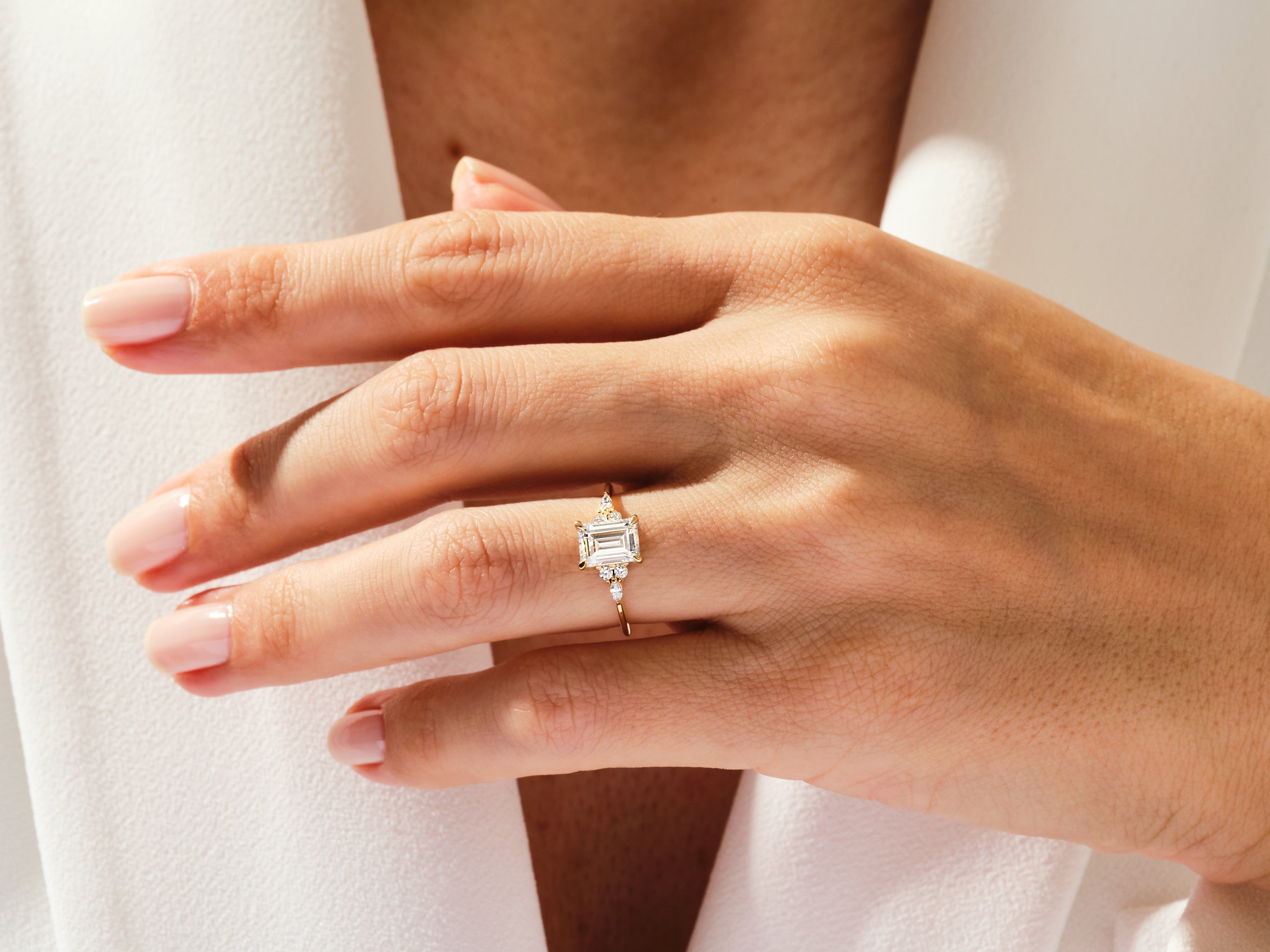 Emerald cut diamond engagement ring on a woman's hand