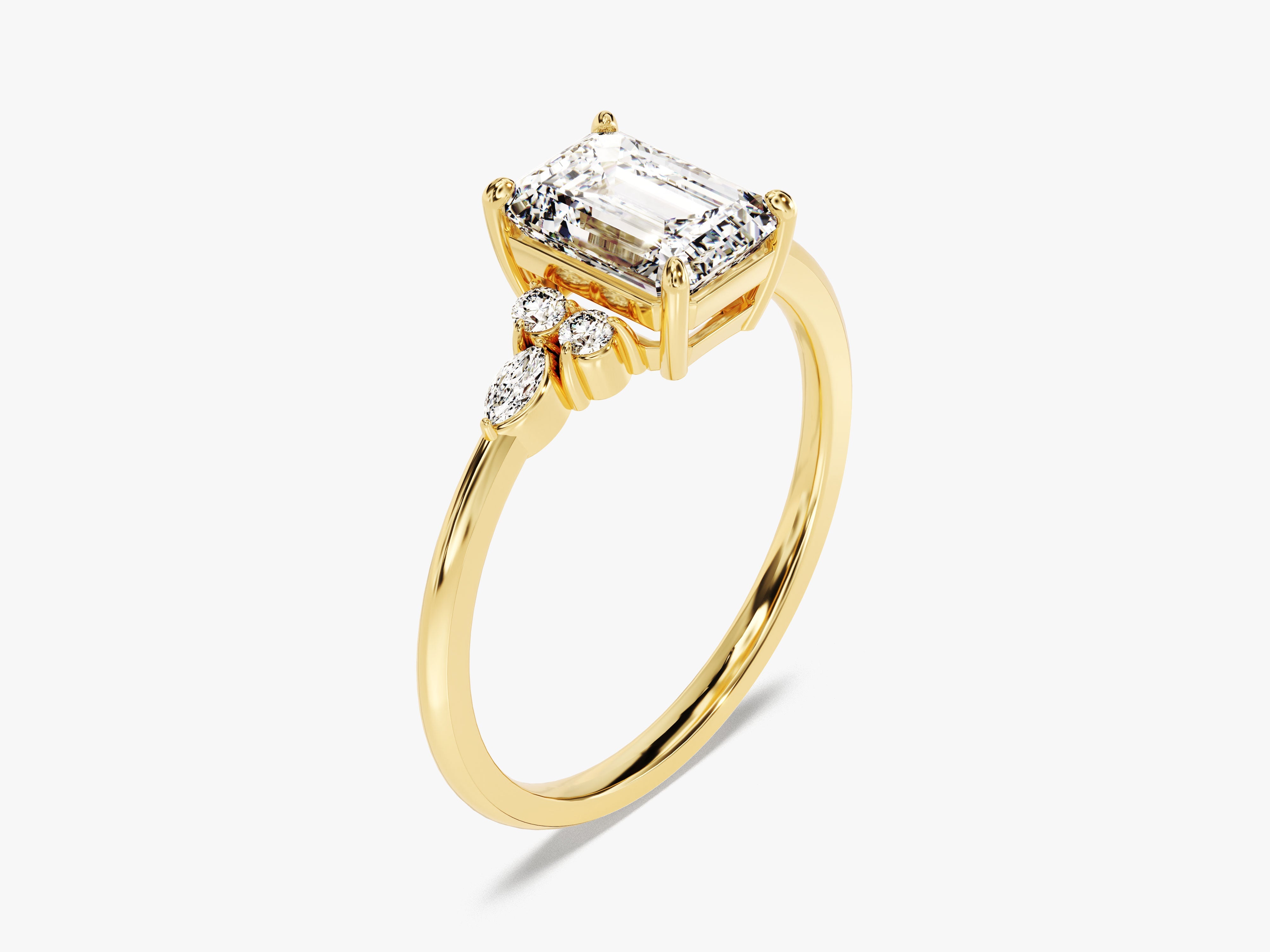 Emerald cut diamond ring with accent stones on yellow gold band