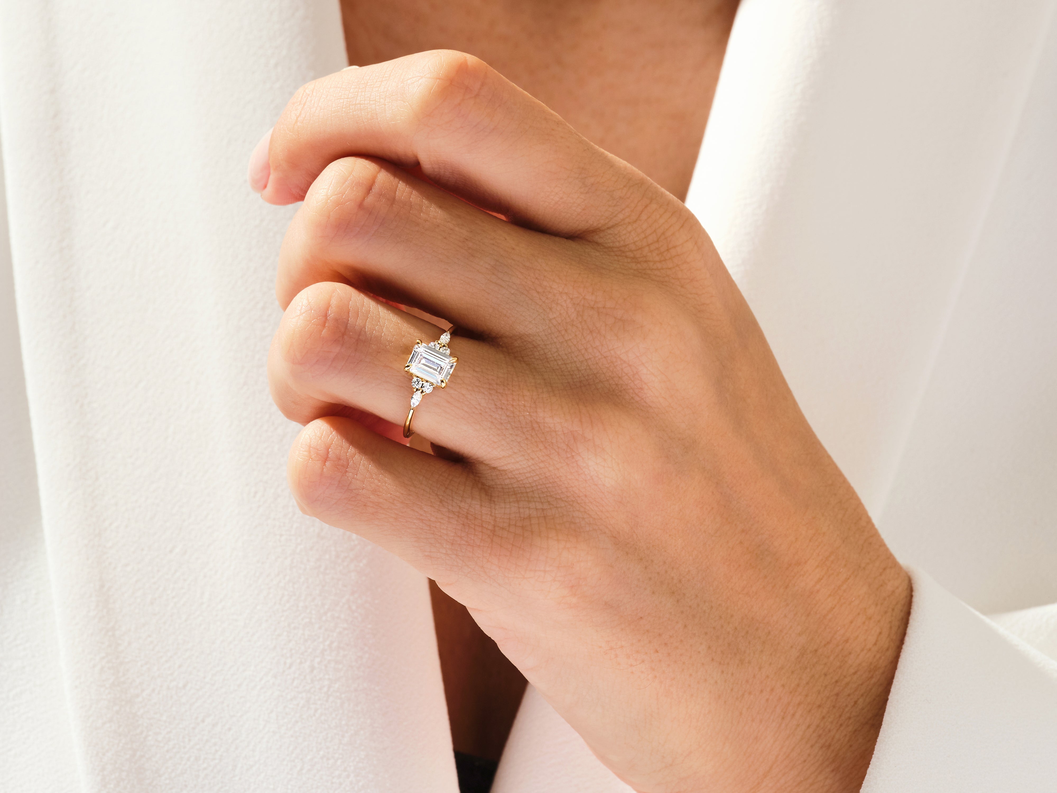 Emerald cut diamond ring on a hand, fine jewelry